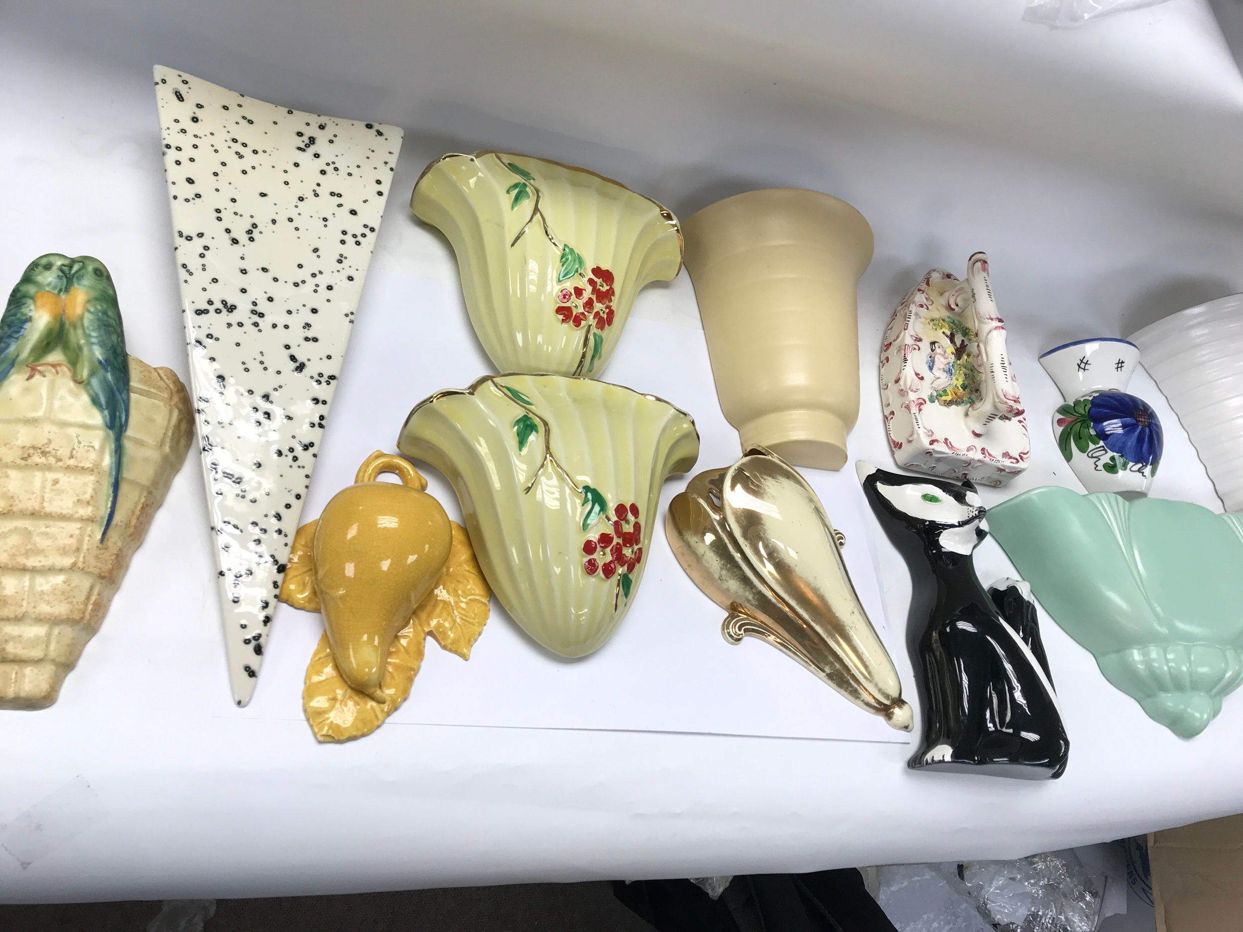 collection of vintage ceramic wall pockets and wall vases in various mid-20th-century shapes and designs