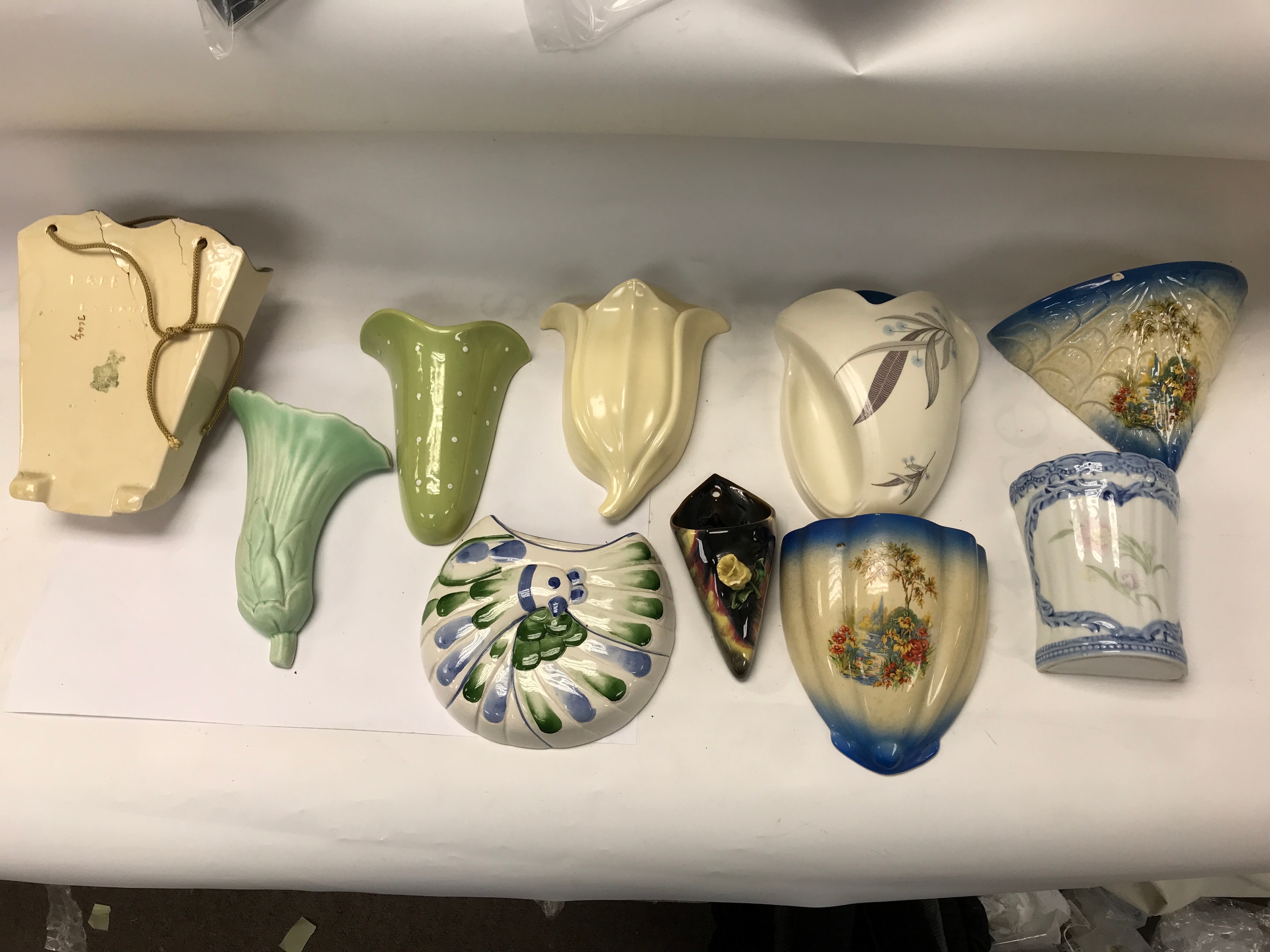 collection of vintage ceramic wall pockets and wall vases in various mid-20th-century shapes and designs