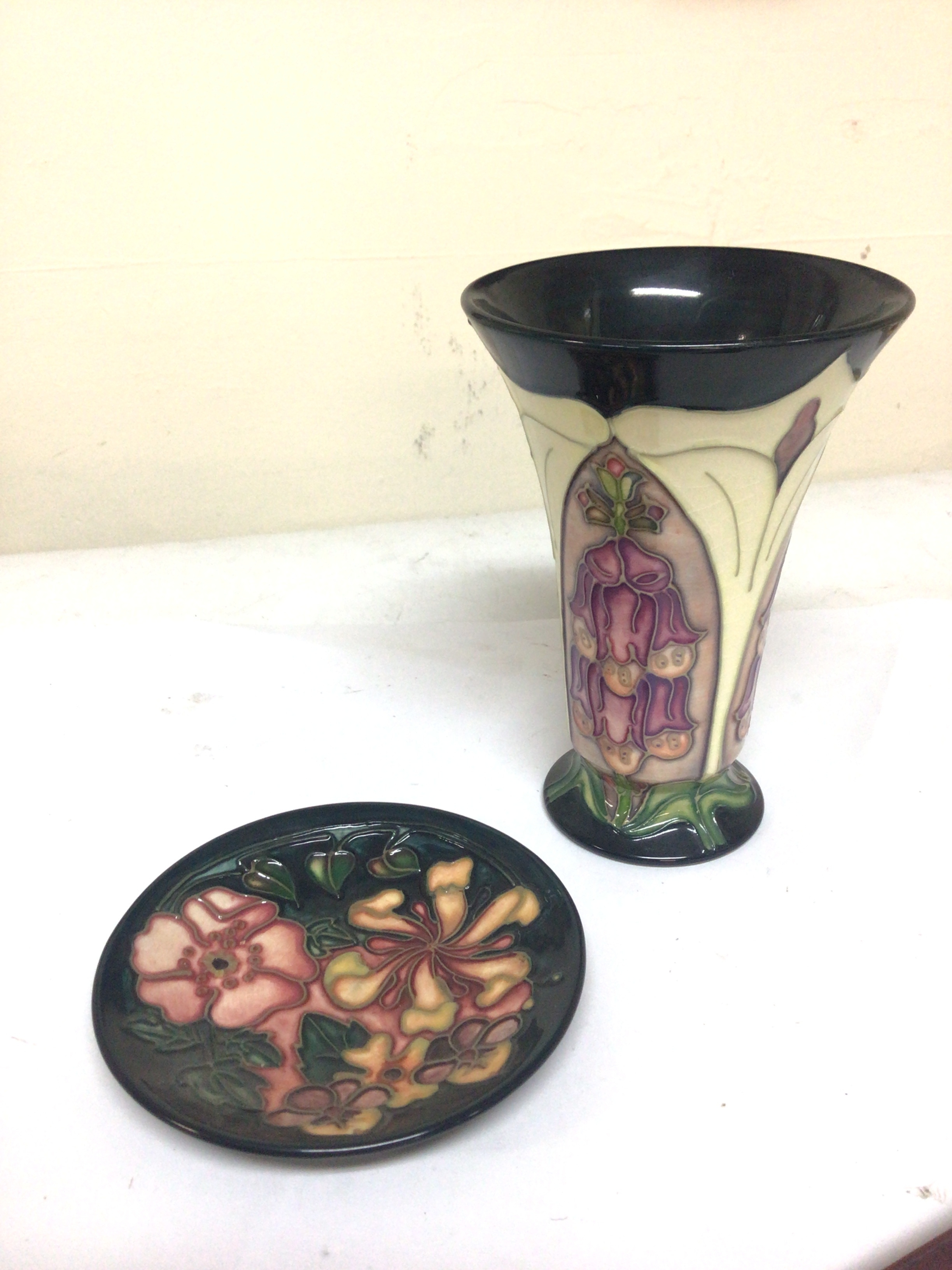  A Moorcroft vase Foxglove pattern hight 15cm and one othwr smaller Moorcroft dish no obvious damage 