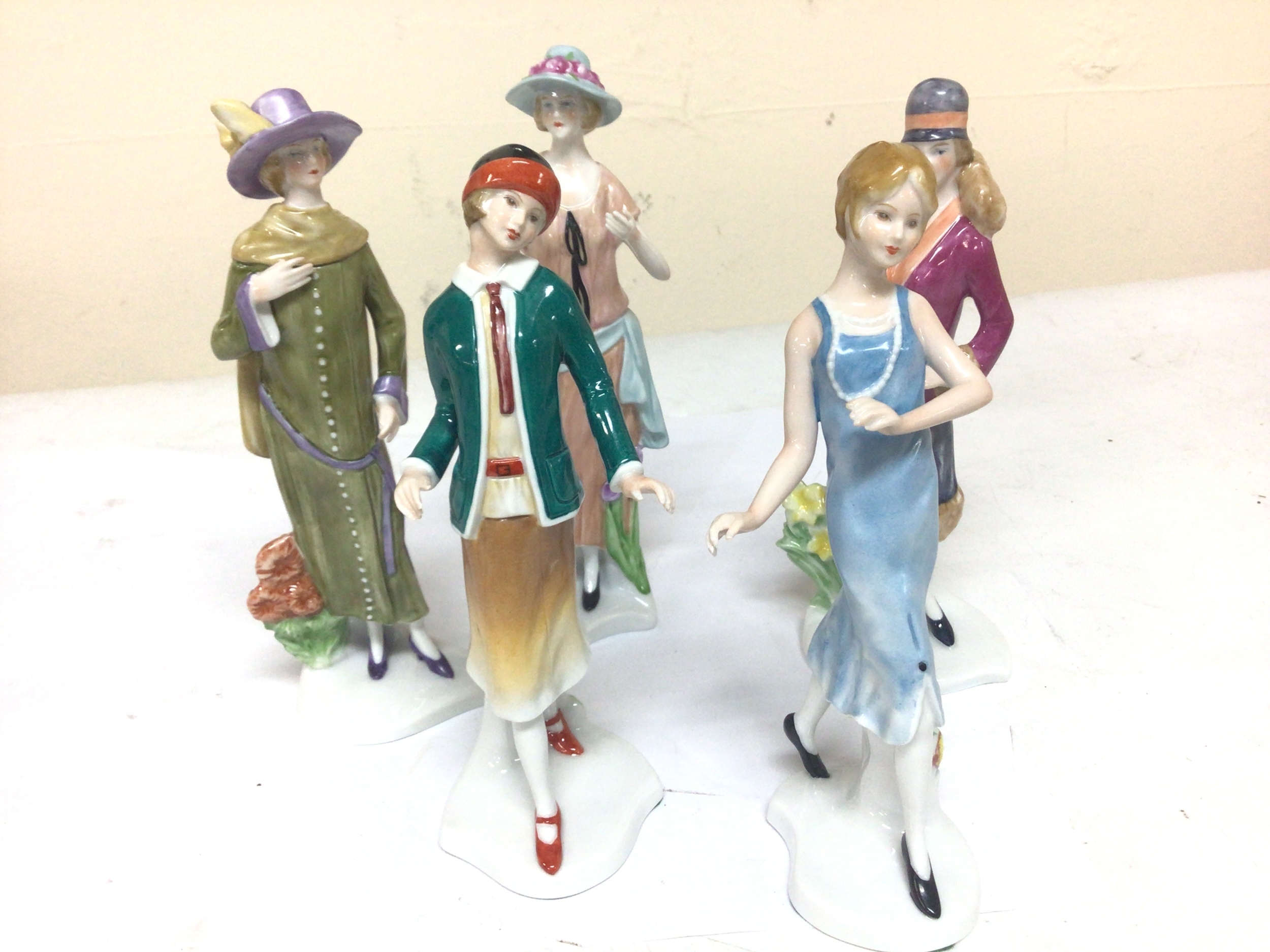  A collection of 20th century German porcelain figures of ladies in 1920-30 fashion dresses. Hight 18cm