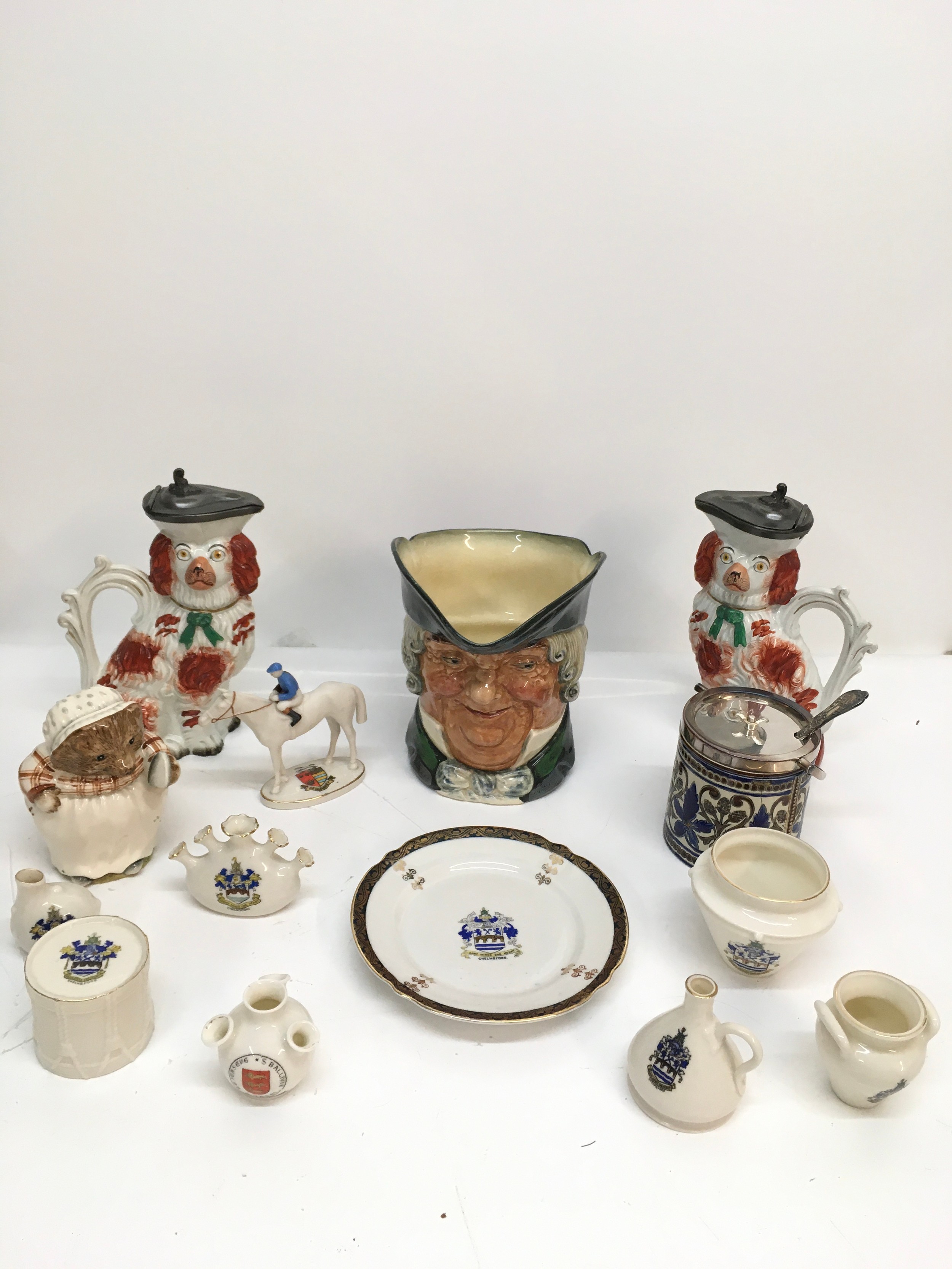 A small group of ceramics including Staffordshire dogs jugs and crested china