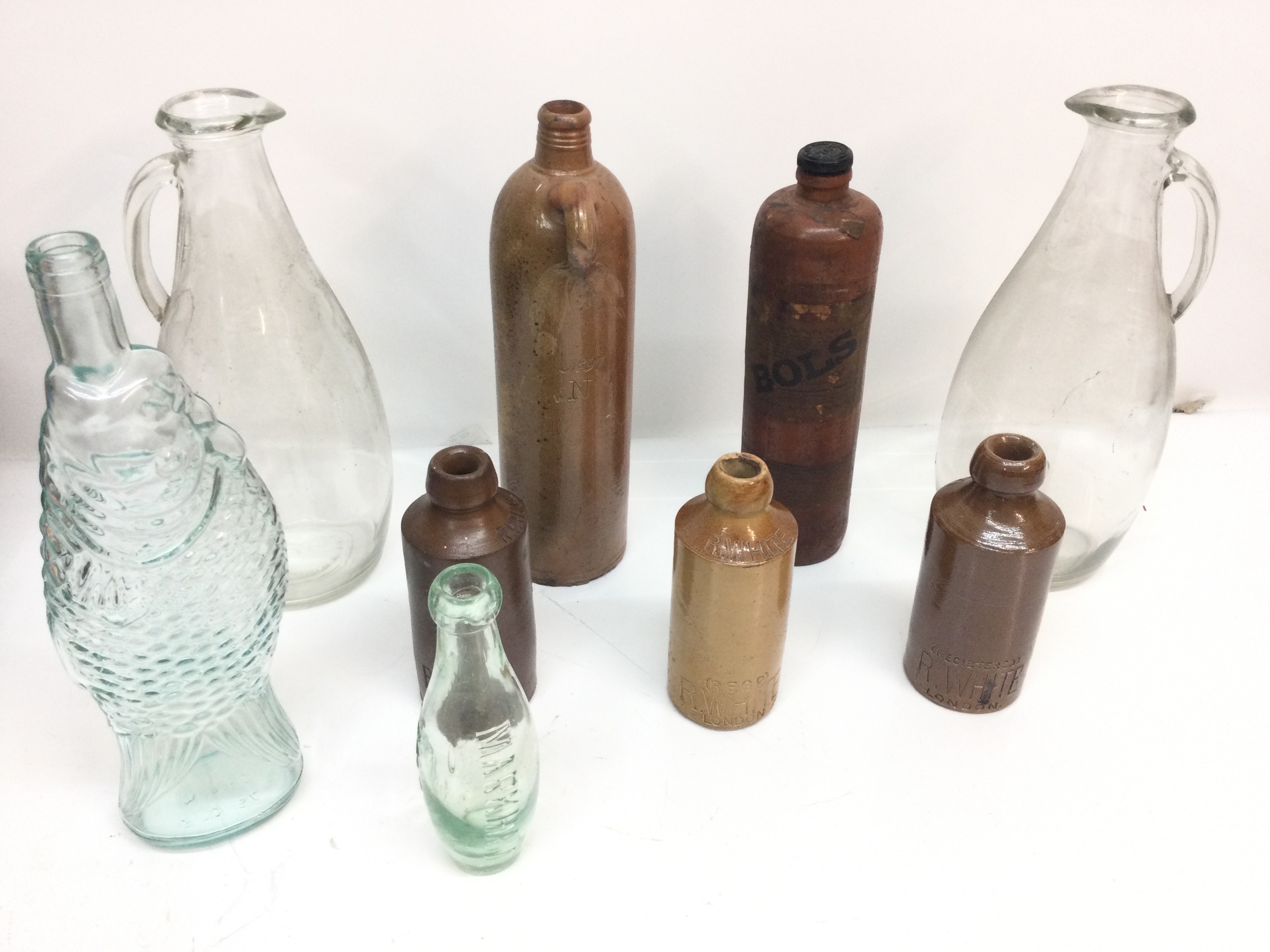 A small group of antique stoneware and glass bottles