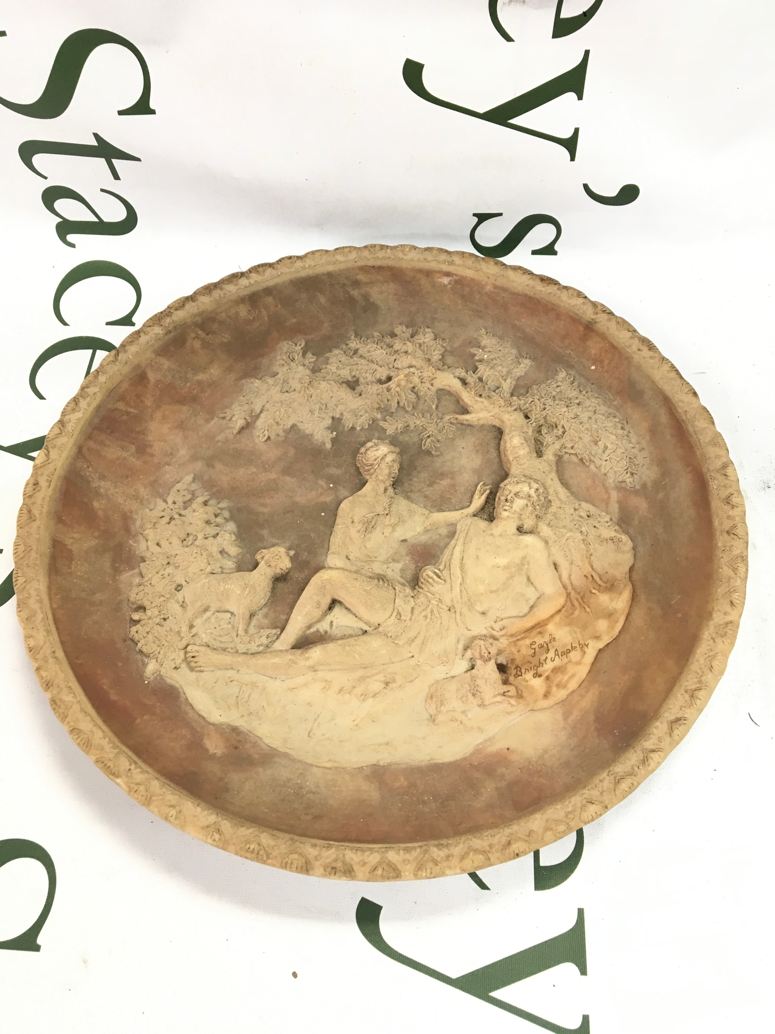 A 19th century pottery dish with raised figures under a tree with lambs signed 'Garyle Bright Appleby'