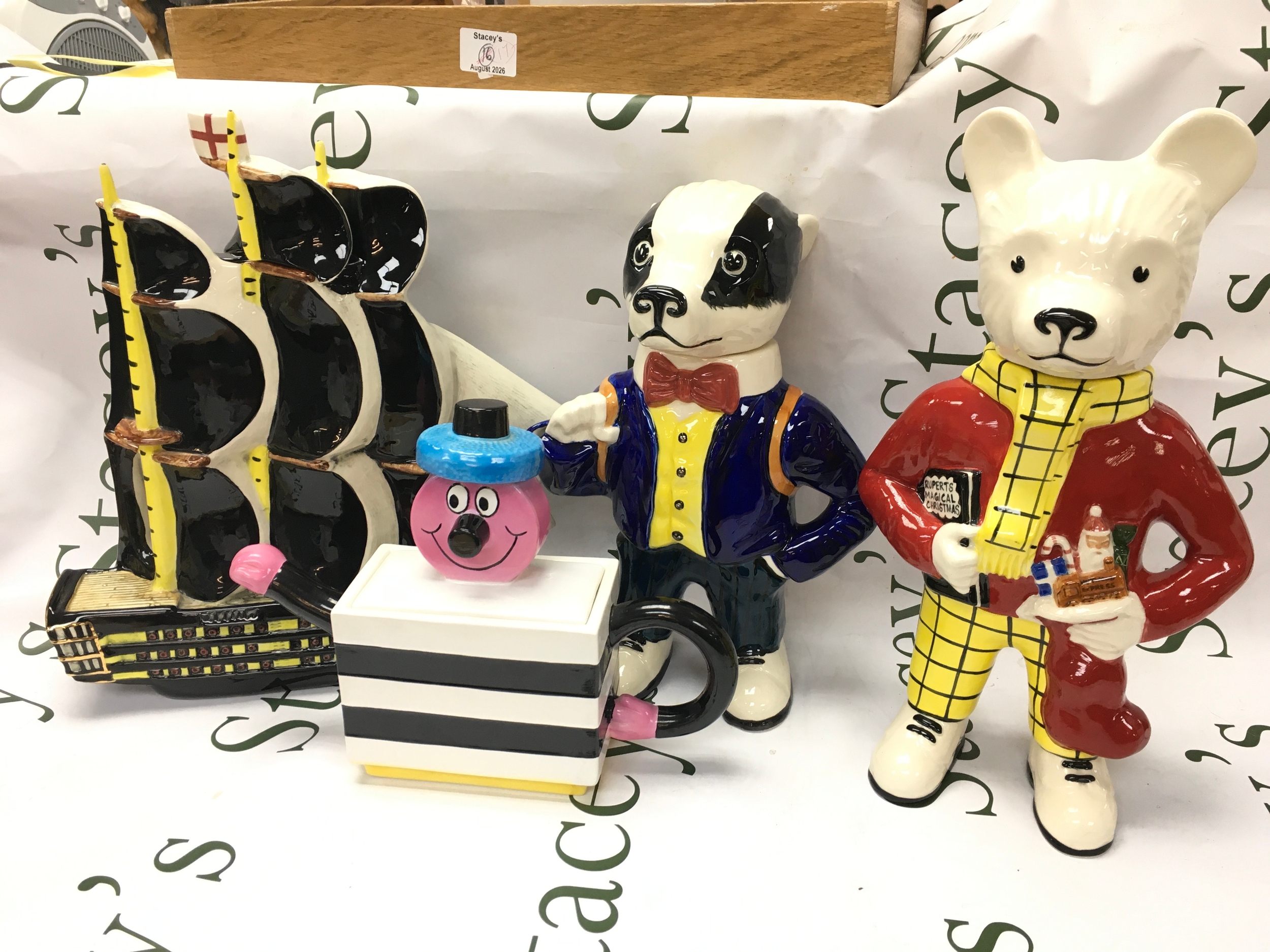 Four ceramic teapots including Gary Seymour Rupert the Bear and Bill Badger, Wood pottery of Burslem Bettie Bassett, Gary Seymour Trafalgar Bicentenary 8/47 ship tea pot . 22 to 34cm tall