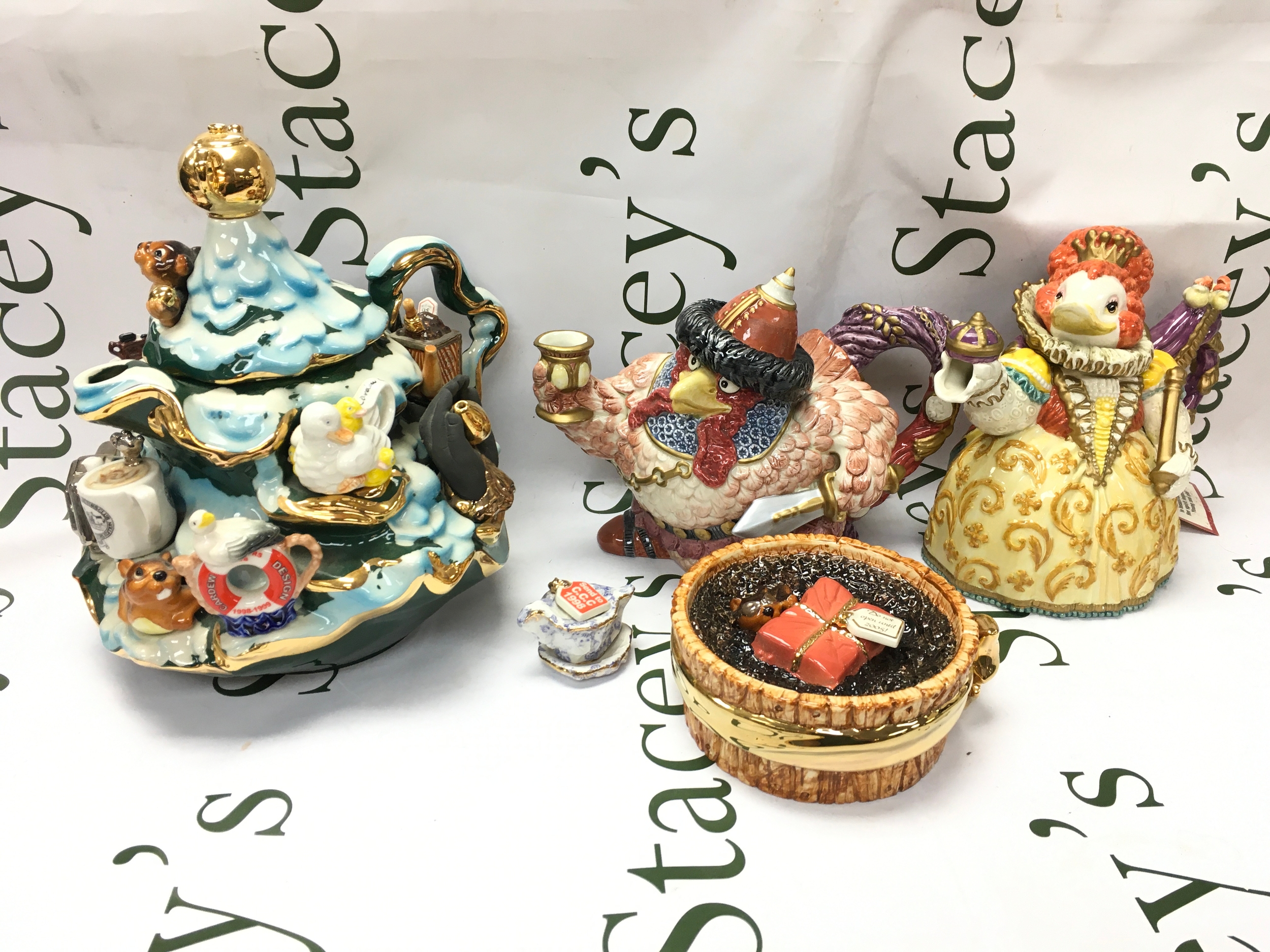 Three porcelain tea jugs including Fitz and Floyd Attila the Hen, Queen Elizabird, Paul Cardew signed ashtray 2004 5/50, Cardew collectors club 1999-2004 jug