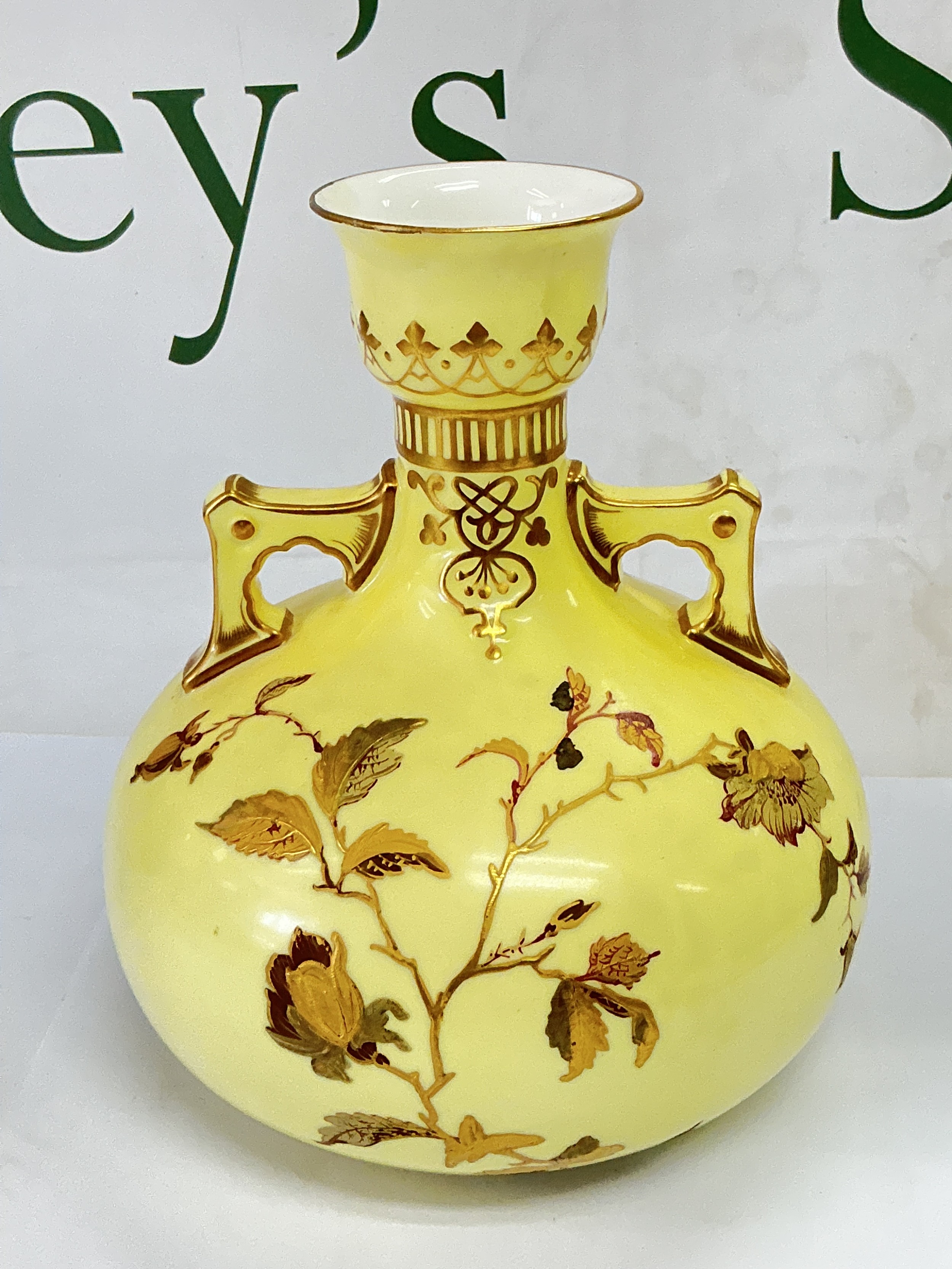 A Royal Crown Derby vase of squat form with giltwork floral decoration on a yellow ground, approx height 17cm. NO RESERVE