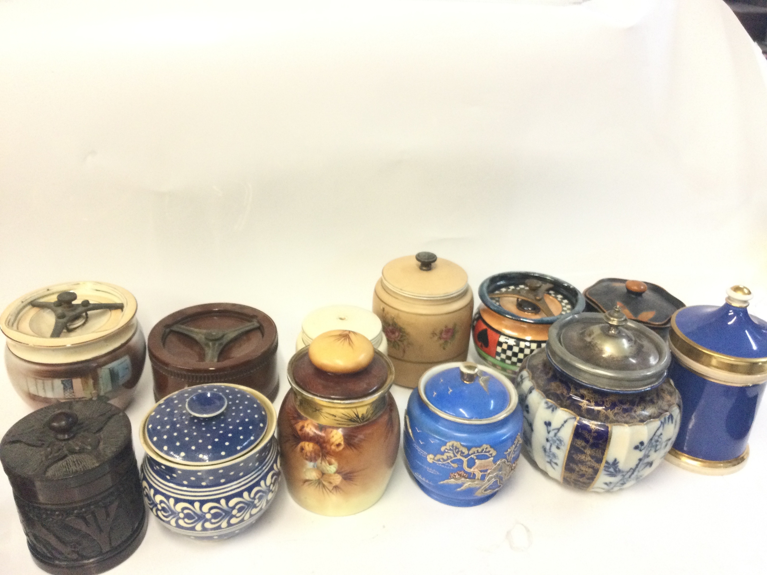 A collection of biscuit barrels and tobacco jars including ceramic and wooden examples by AFC, Favorite Bavarie, Royal Doulton & Slaters NO RESERVE