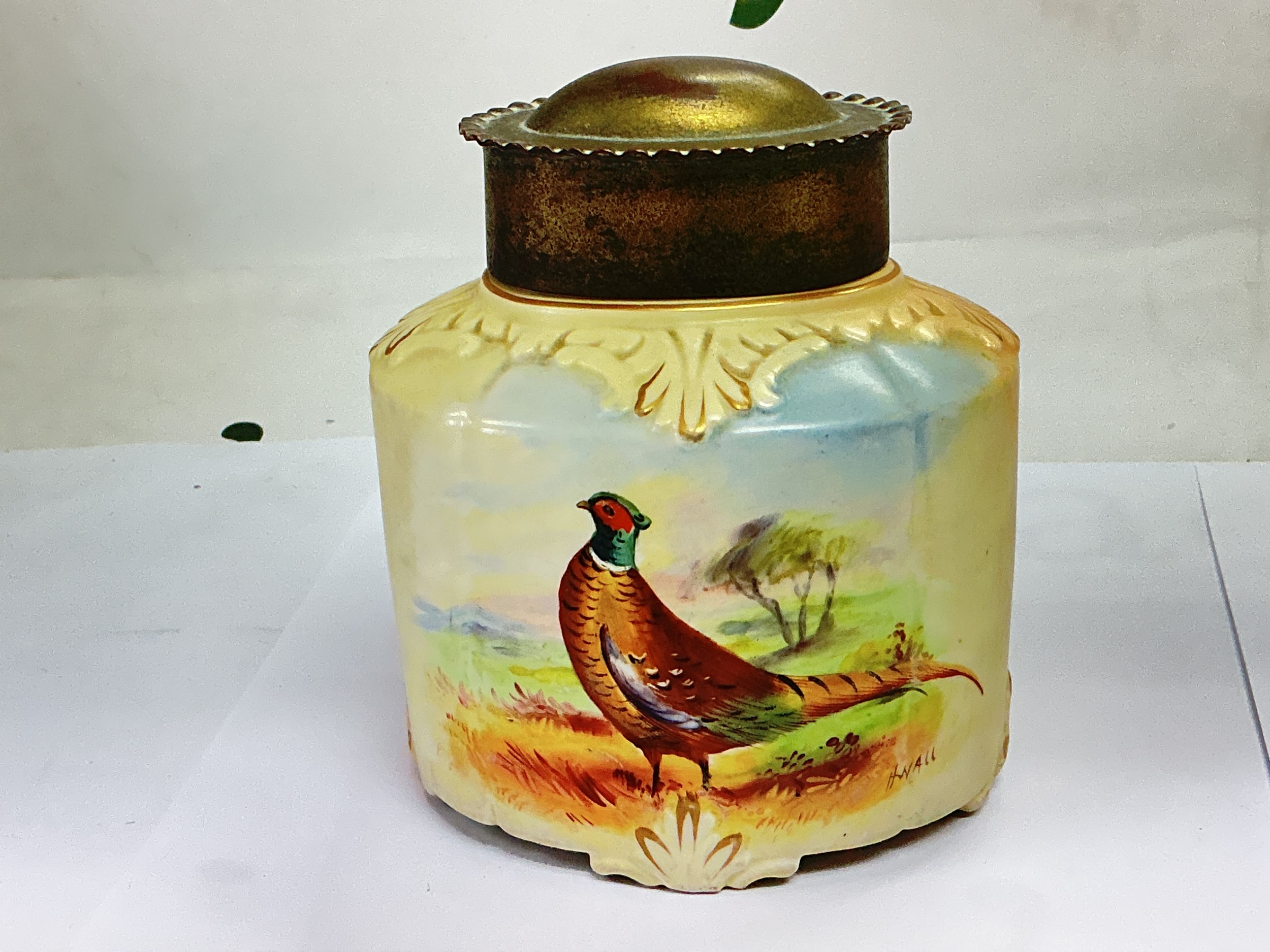 An early 20th Century Locke & Co blush ivory jar and cover with hand painted decoration of a pheasant, approx height 12cm. NO RESERVE