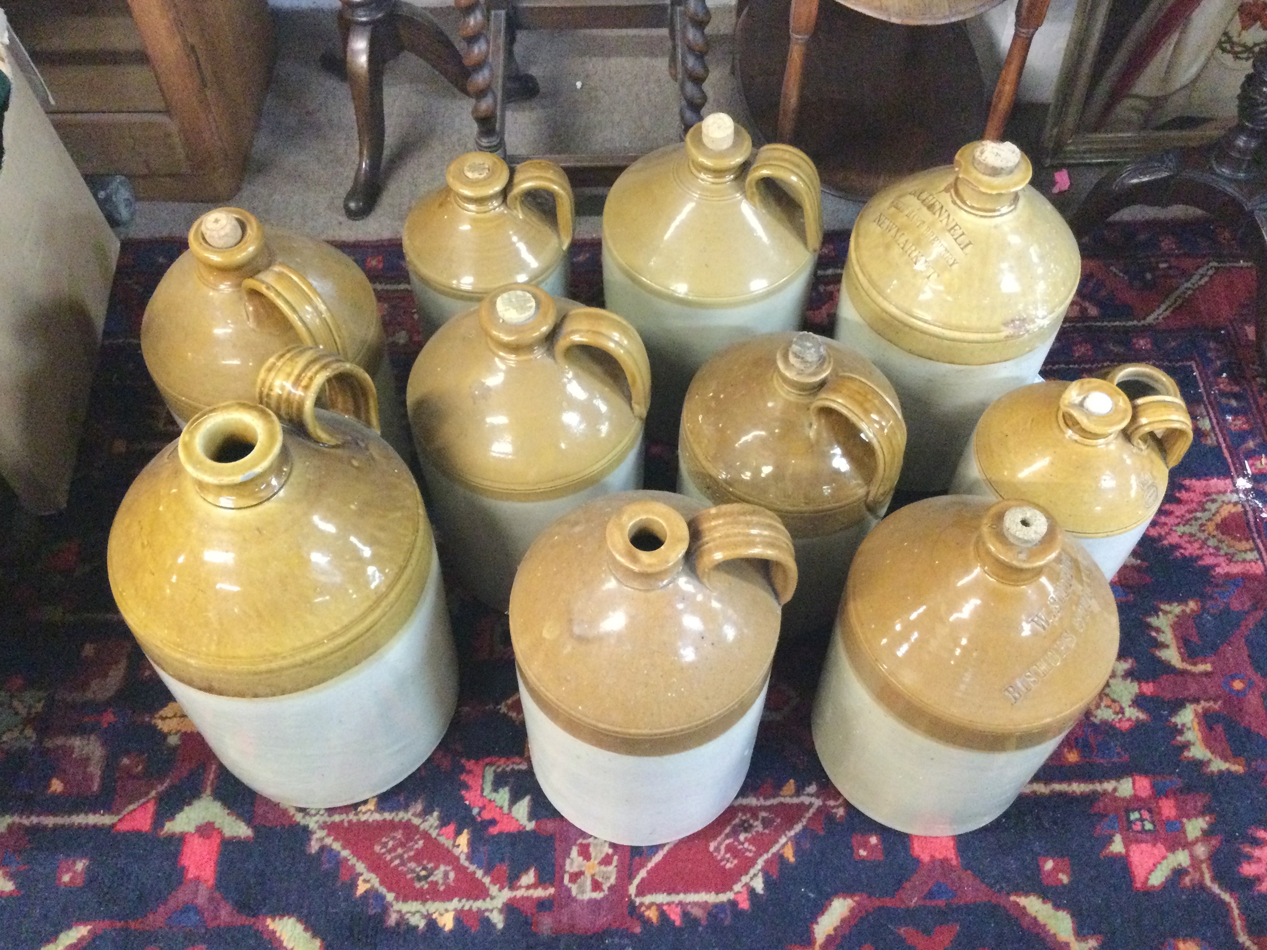 A collection of 11 ceramic stoneware jugs.
