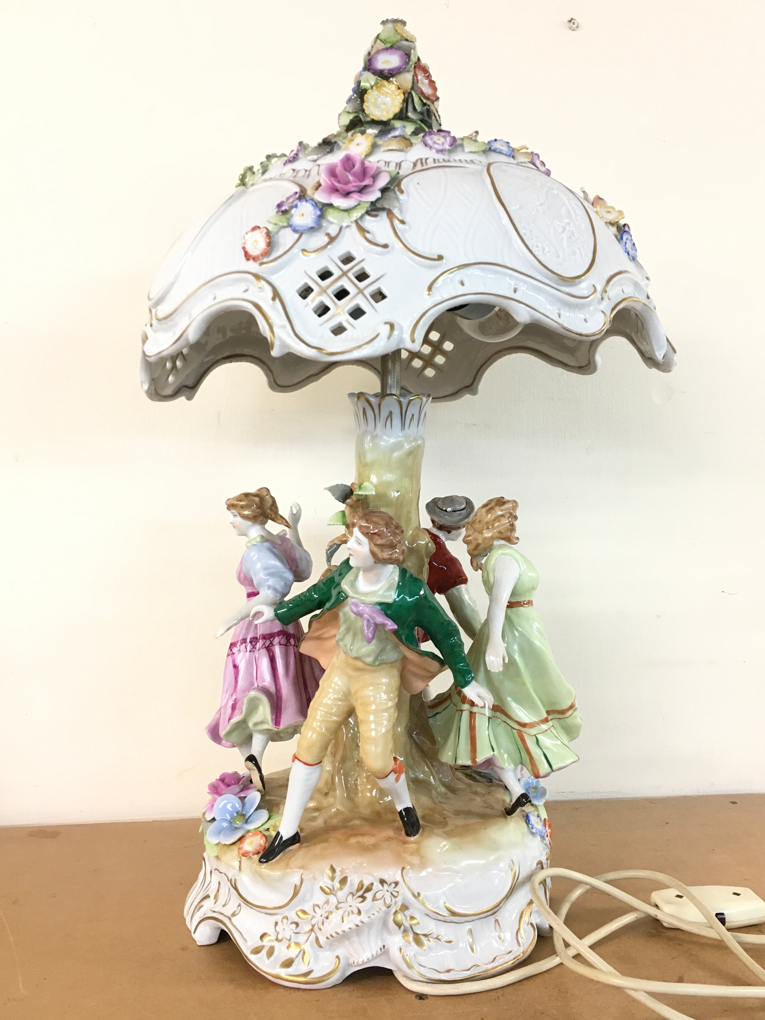 A German porcelain figural table lamp, approximately 60cm tall. Marked Porzellan Manufaktur Plaue (Von Schierholz) Thuringia, Germany dating to the East German (GDR) period between 1949 and 1990