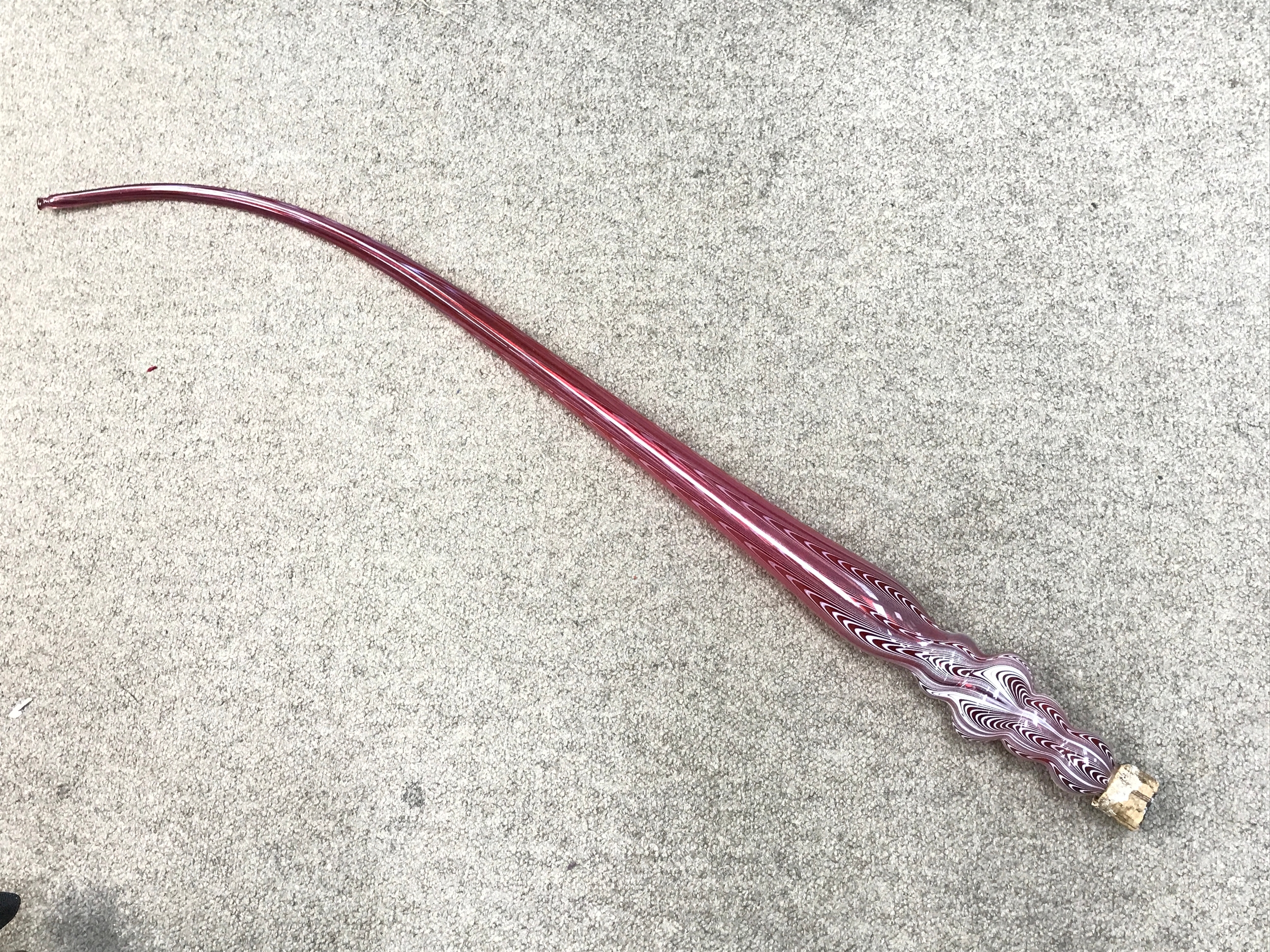 An unusual Victorian glass smoking pipe, Ruby glass and white swirled design. 98cm long 