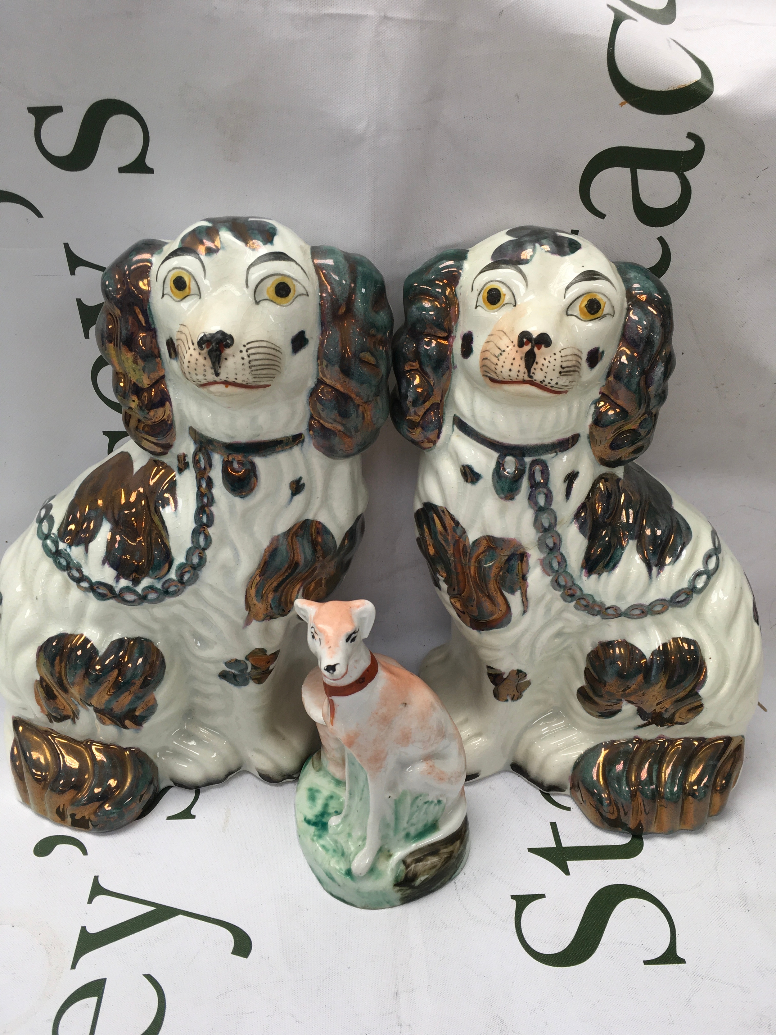A pair of Staffordshire dogs and a ceramic dog ink wall. 
