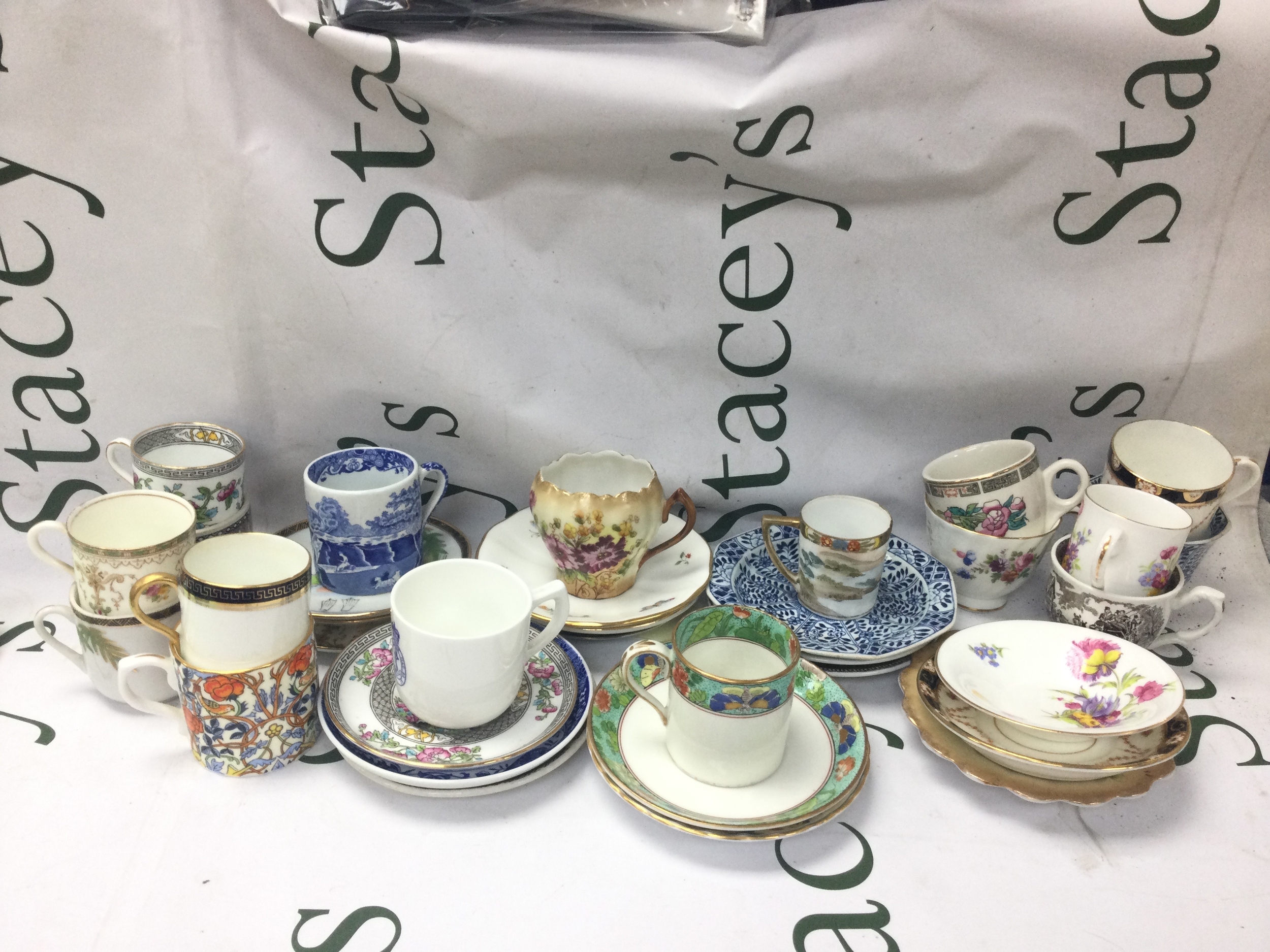 A collection of cups and saucers featuring a wide variety of different patterns 