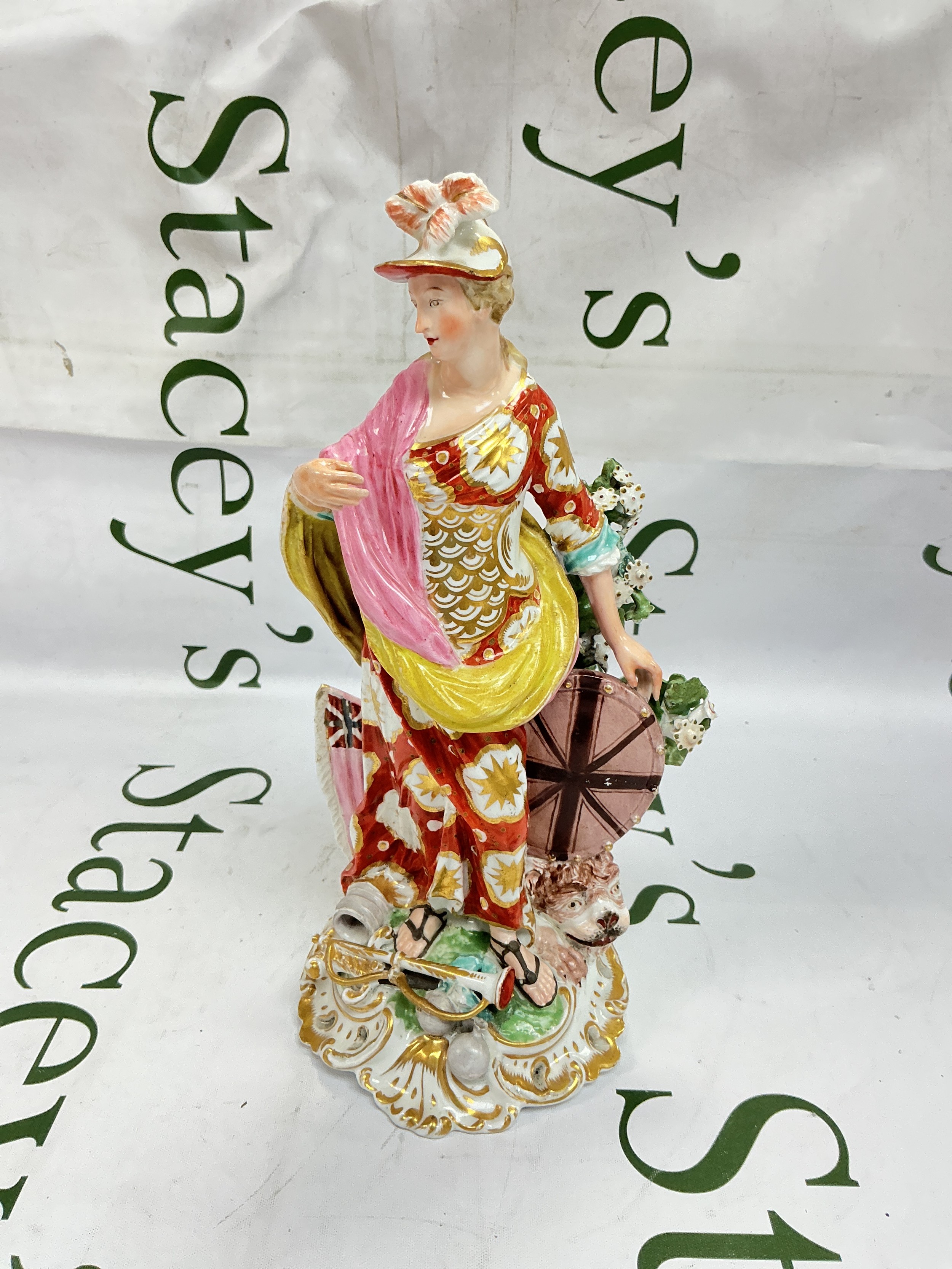 An 18th-century Derby porcelain figure of Britannia, hand-painted in polychrome enamels and gold gilt, featuring the personification of Britain with a shield, lion, and scrolled base. Some chips and restoration. Approx height 24.5cm.