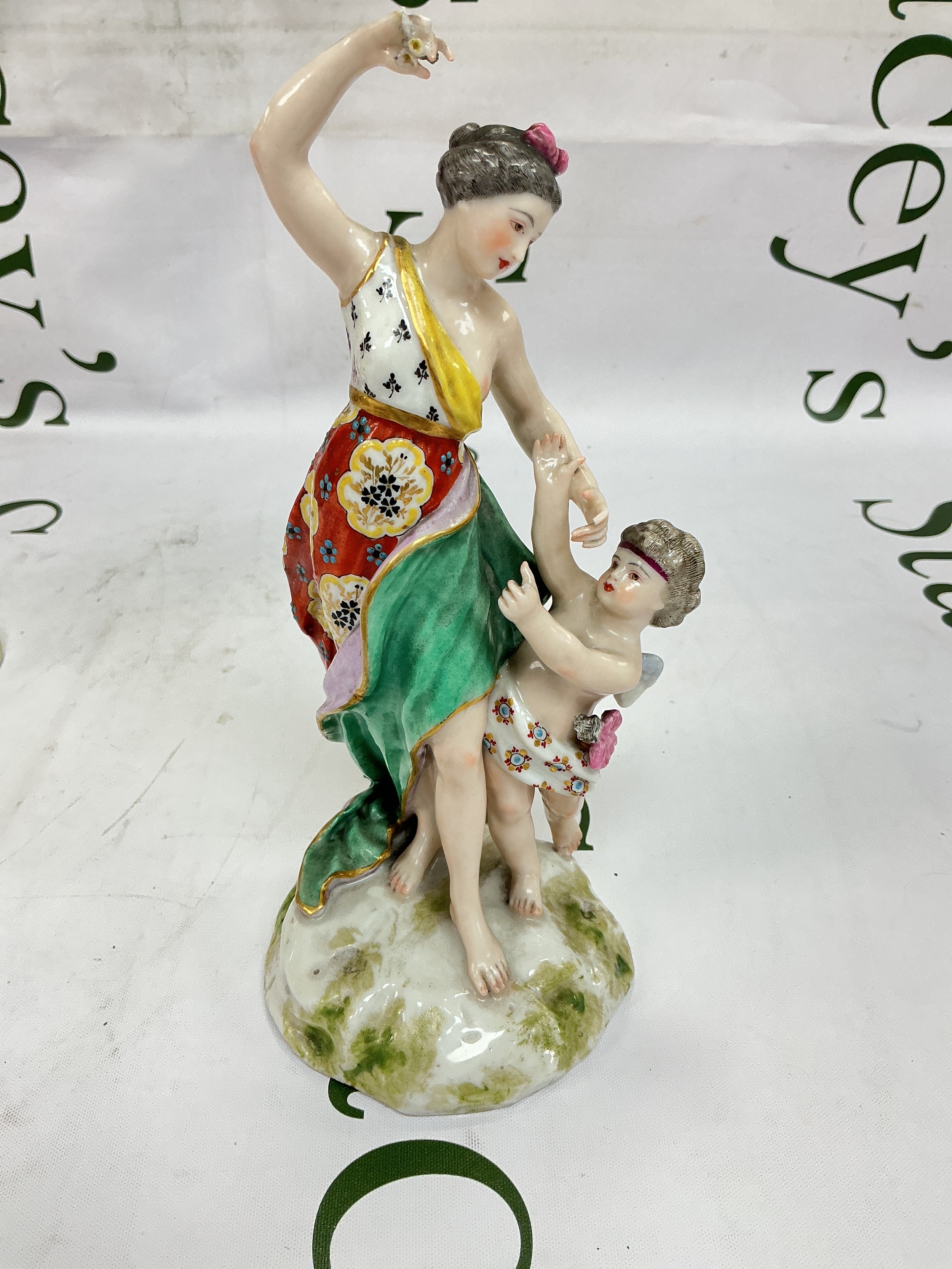 A Royal Crown derby figural group of Venus and Cupid, some damage and restoration. Approx height 19.5cm.