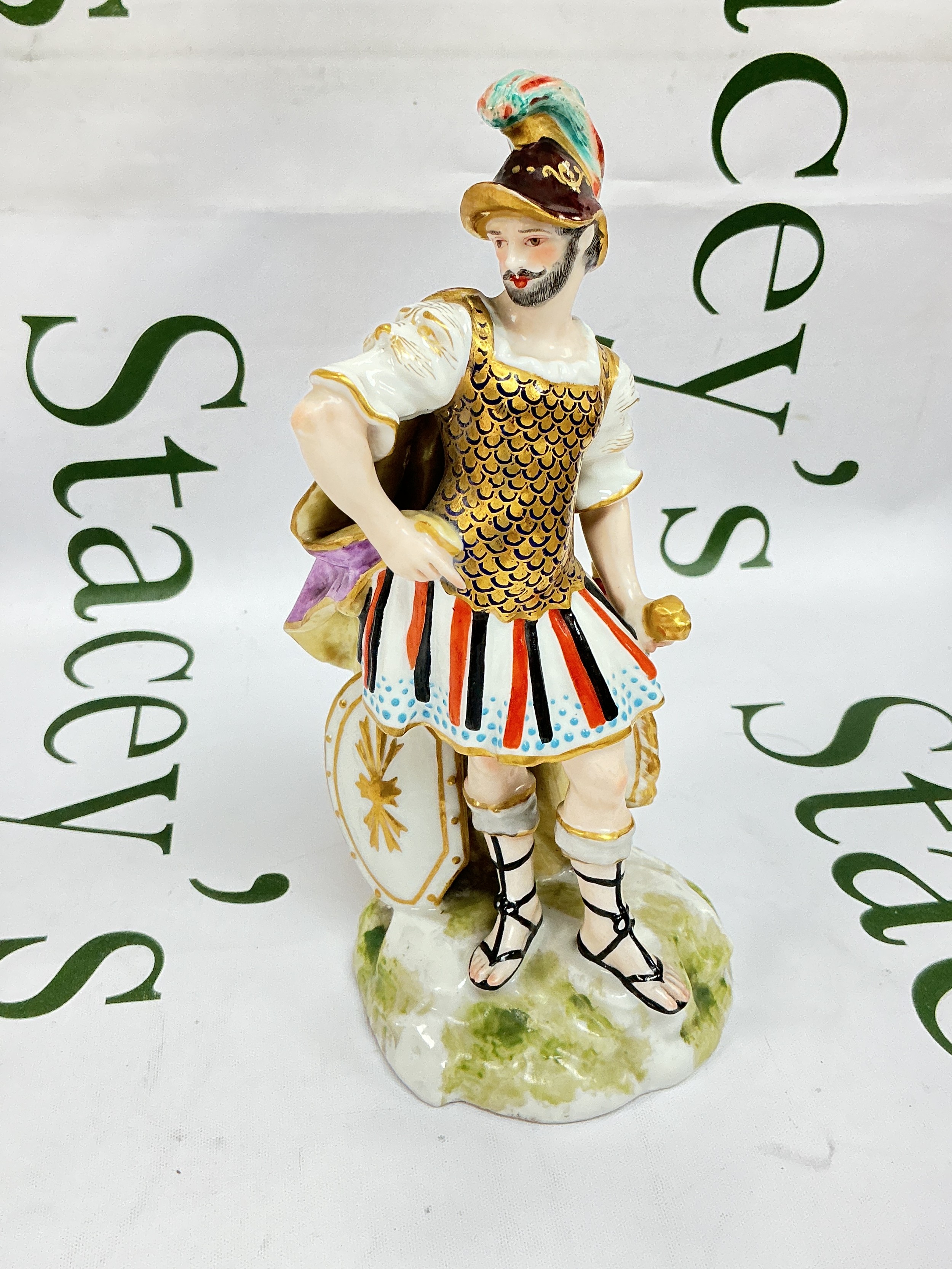 A Crown Derby figure of Mars, the God of War, as a Roman soldier or centurion wearing gilt armour and a plumed helmet. Approx height 19cm.