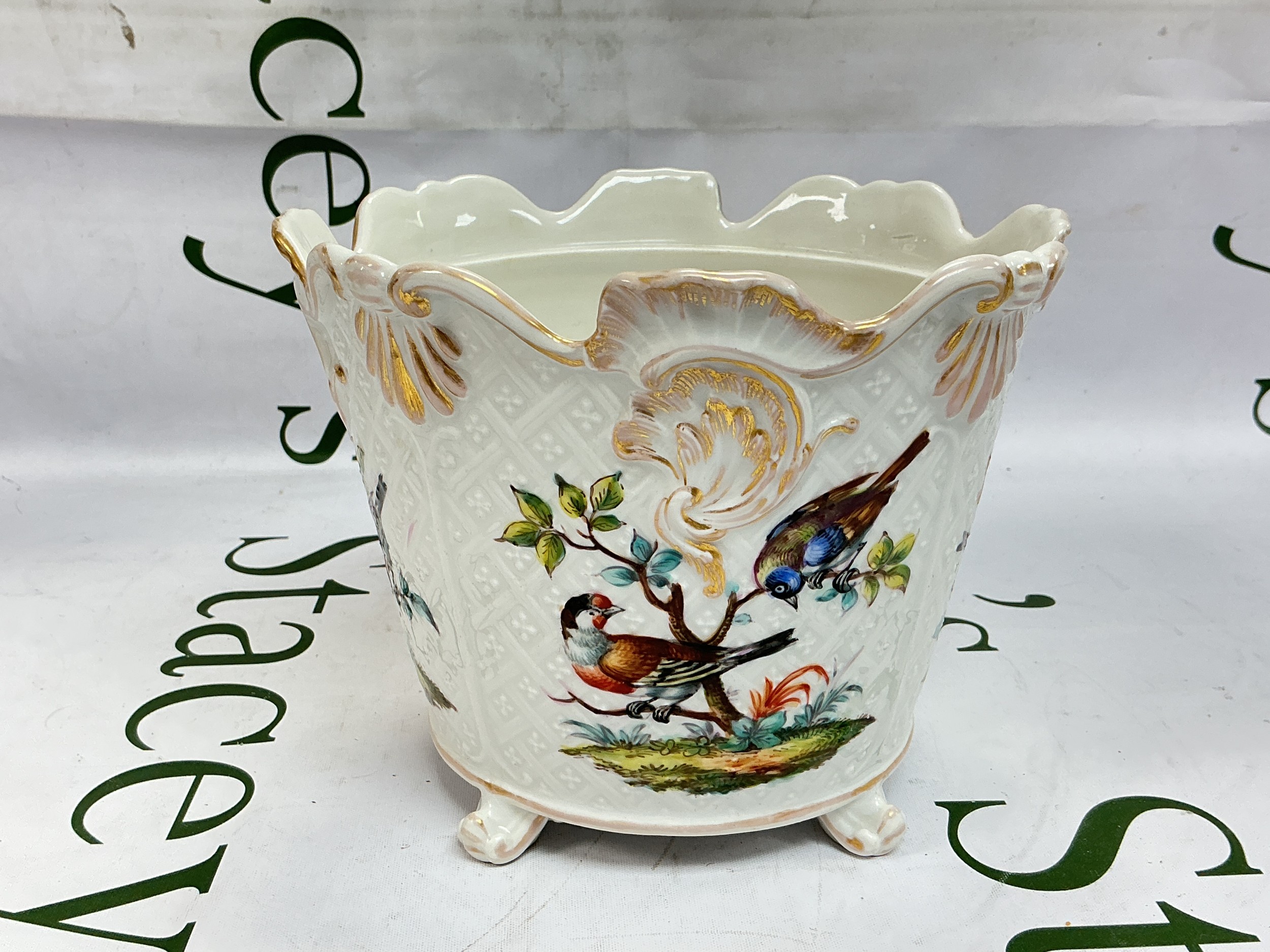 A German cache pot decorated with panels of colourful birds with stylised giltwork motifs, approx height 13.5cm.