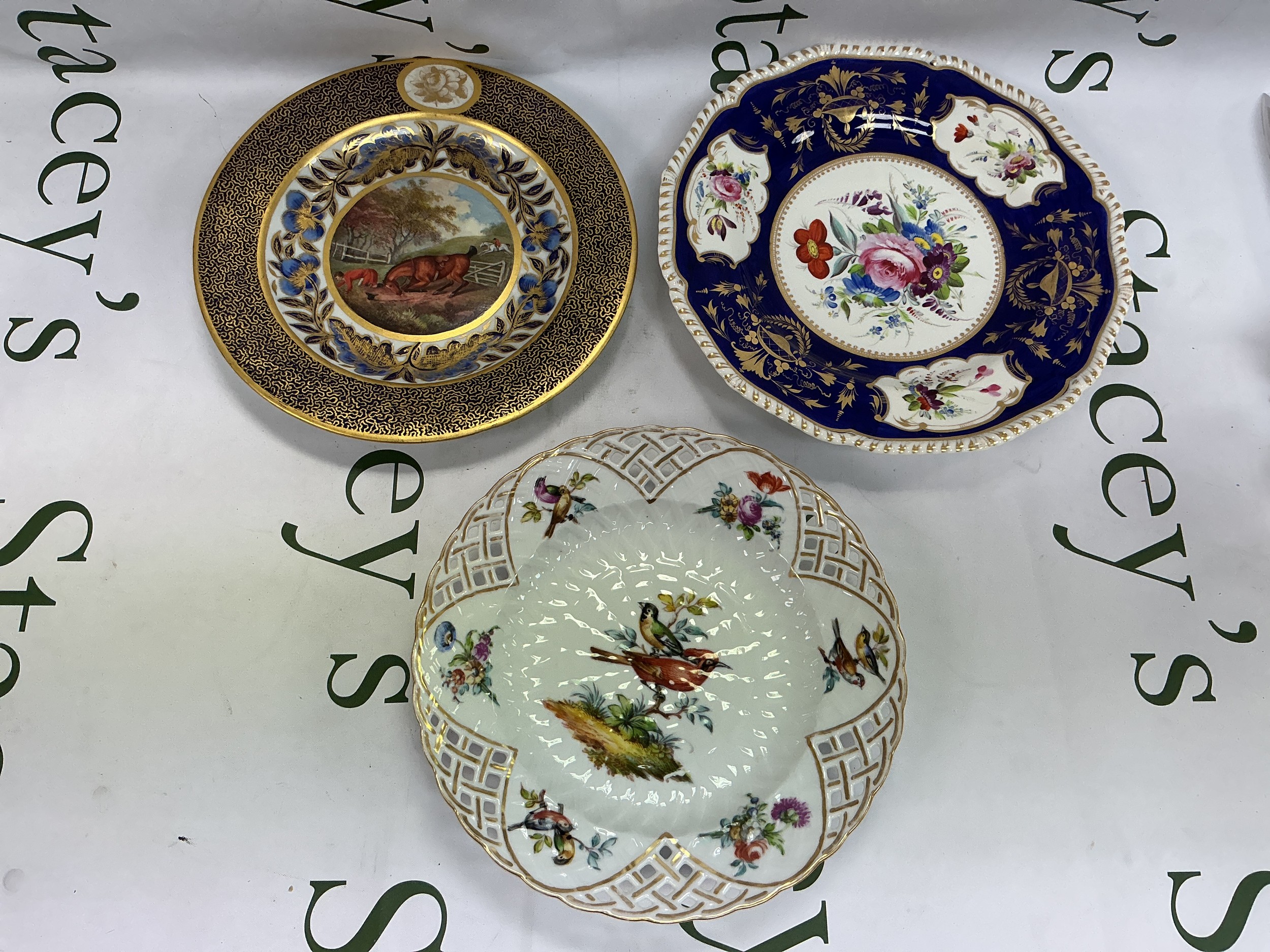 Three cabinet plates comprising two Derby examples and a Dresden piercework plate, largest approx 26cm.