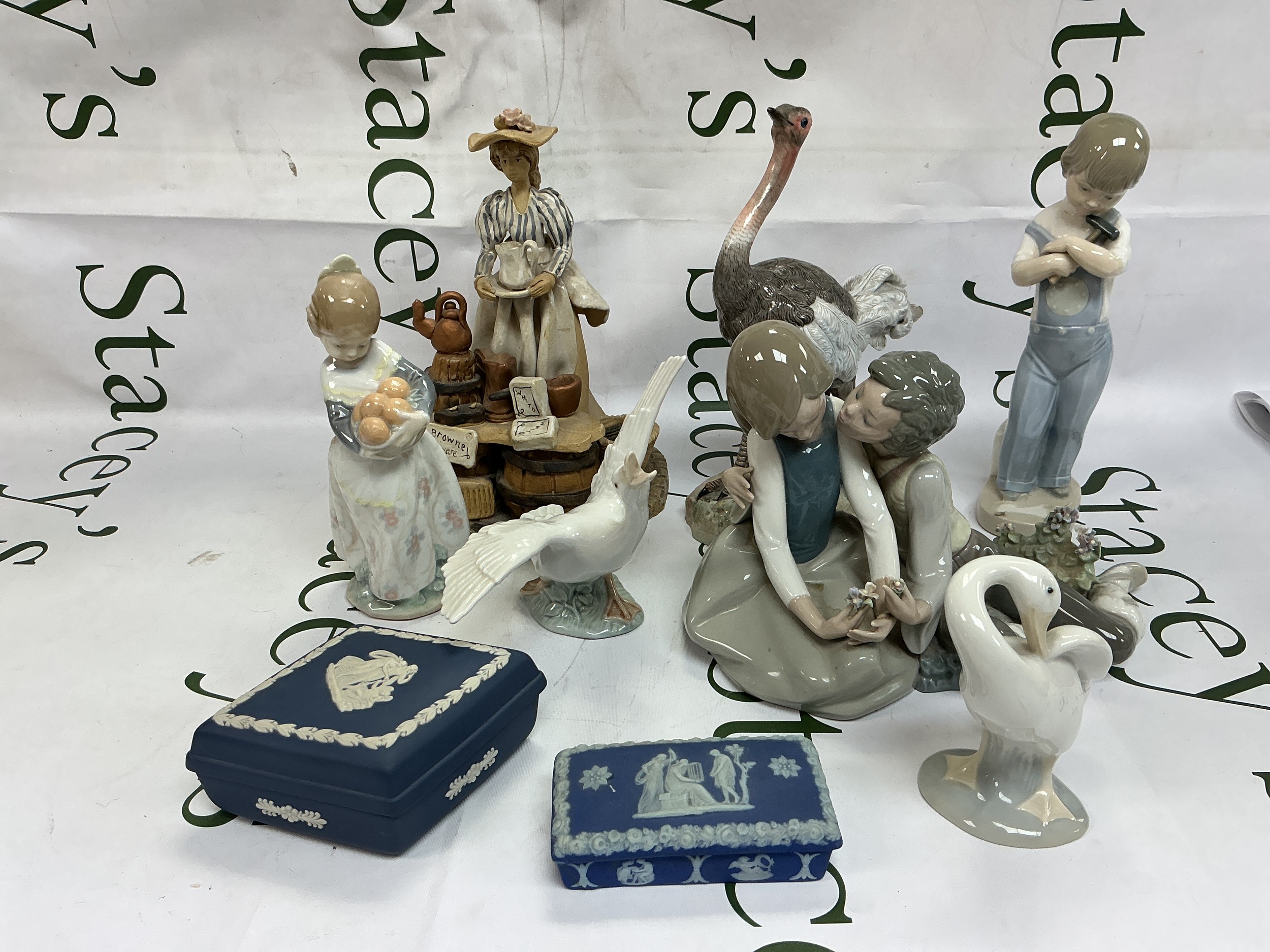 A collection of ceramic figures comprising Lladro and other examples plus two Wedgwood jasperware dressing table pots plus Villeroy & Boch wine glasses.