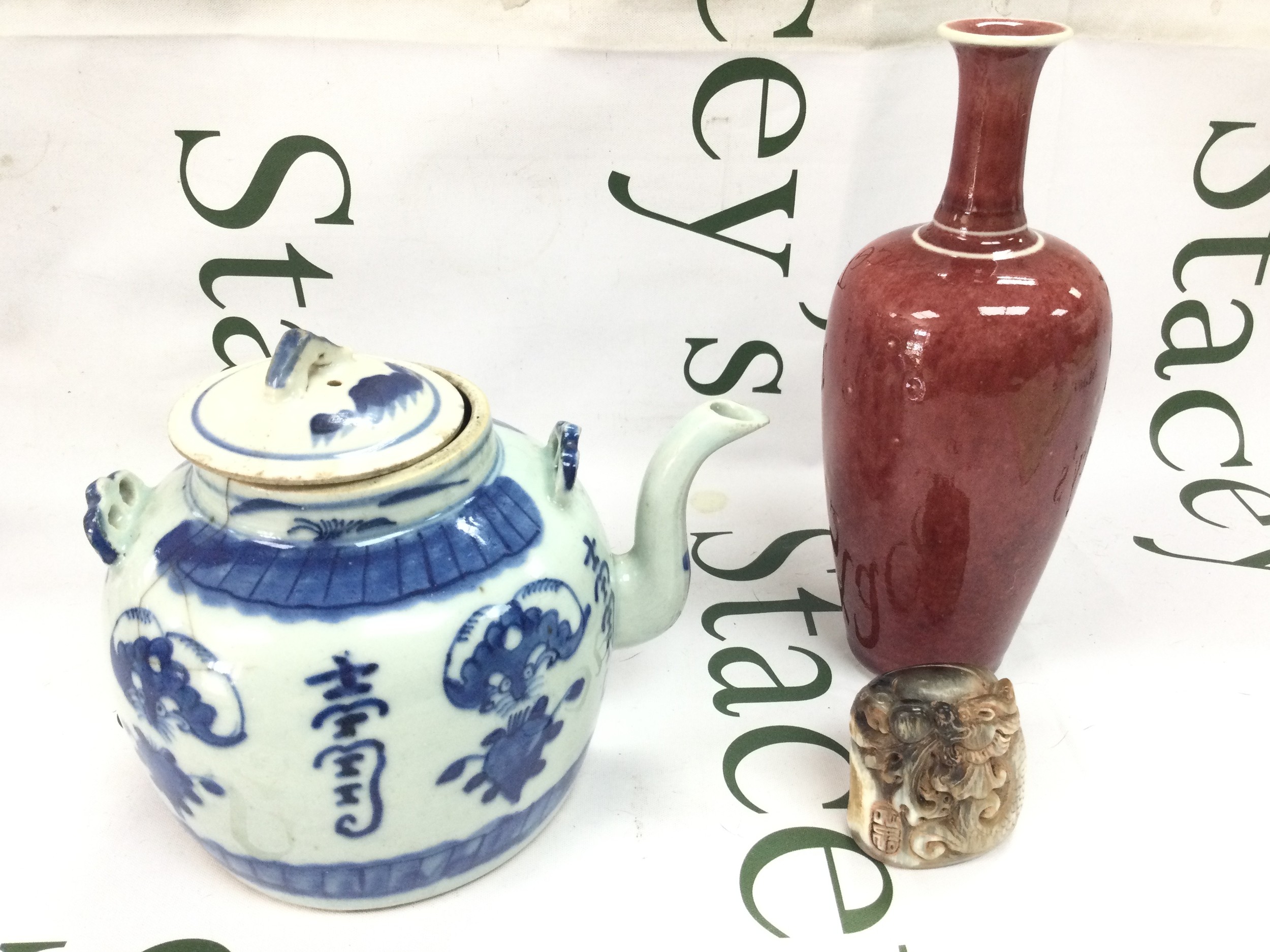 Chinese items including a Blue and white teapot (hairline cracks), red glaze vase with six character mark at base (no obvious damage or restoration), hand carved stone seal. 5-20cm tall