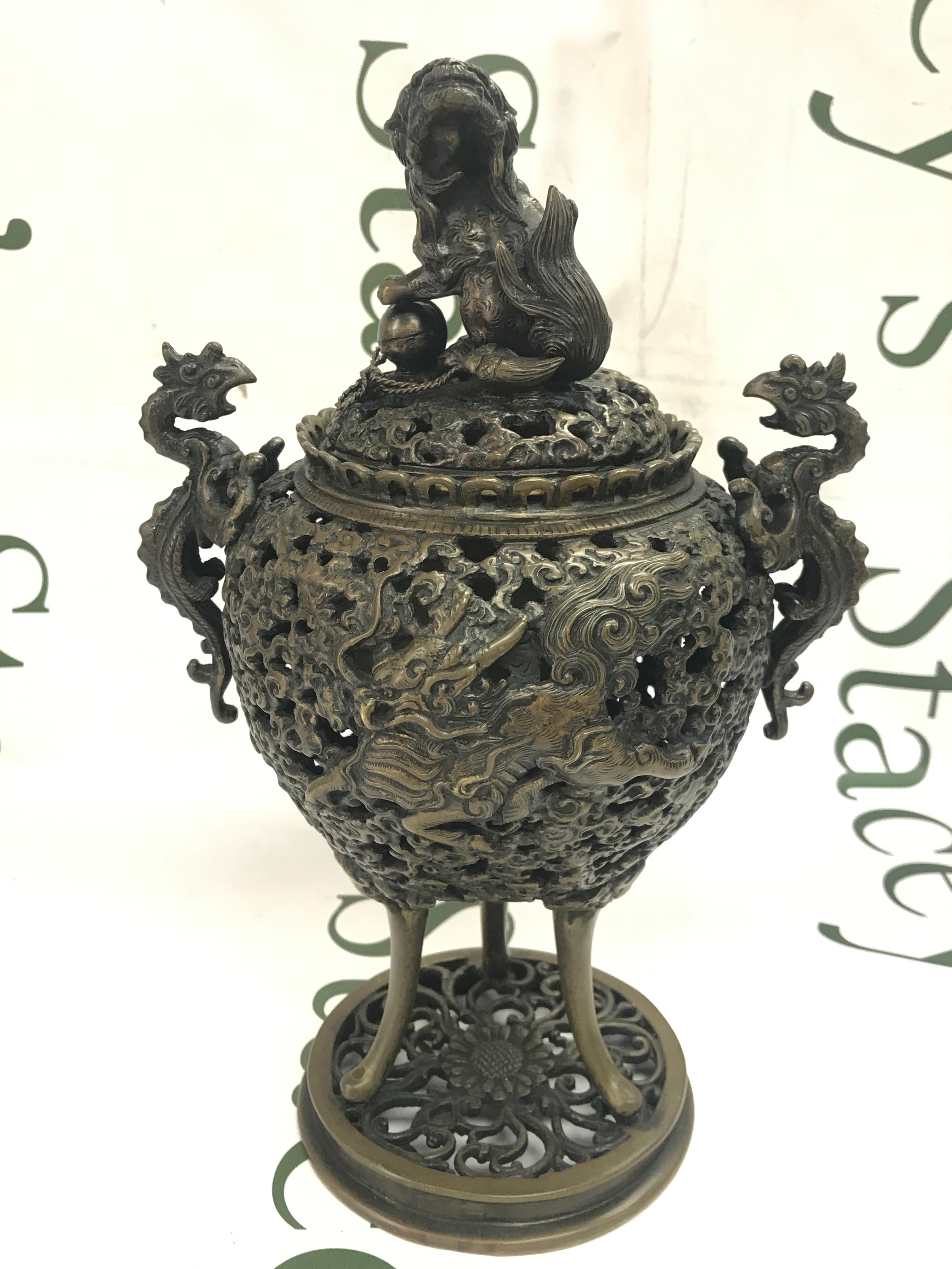A Chinese Bronze Incense burner with pierced openwork body and intricate figures of Dragons and Phoenix's. 28cm tall
