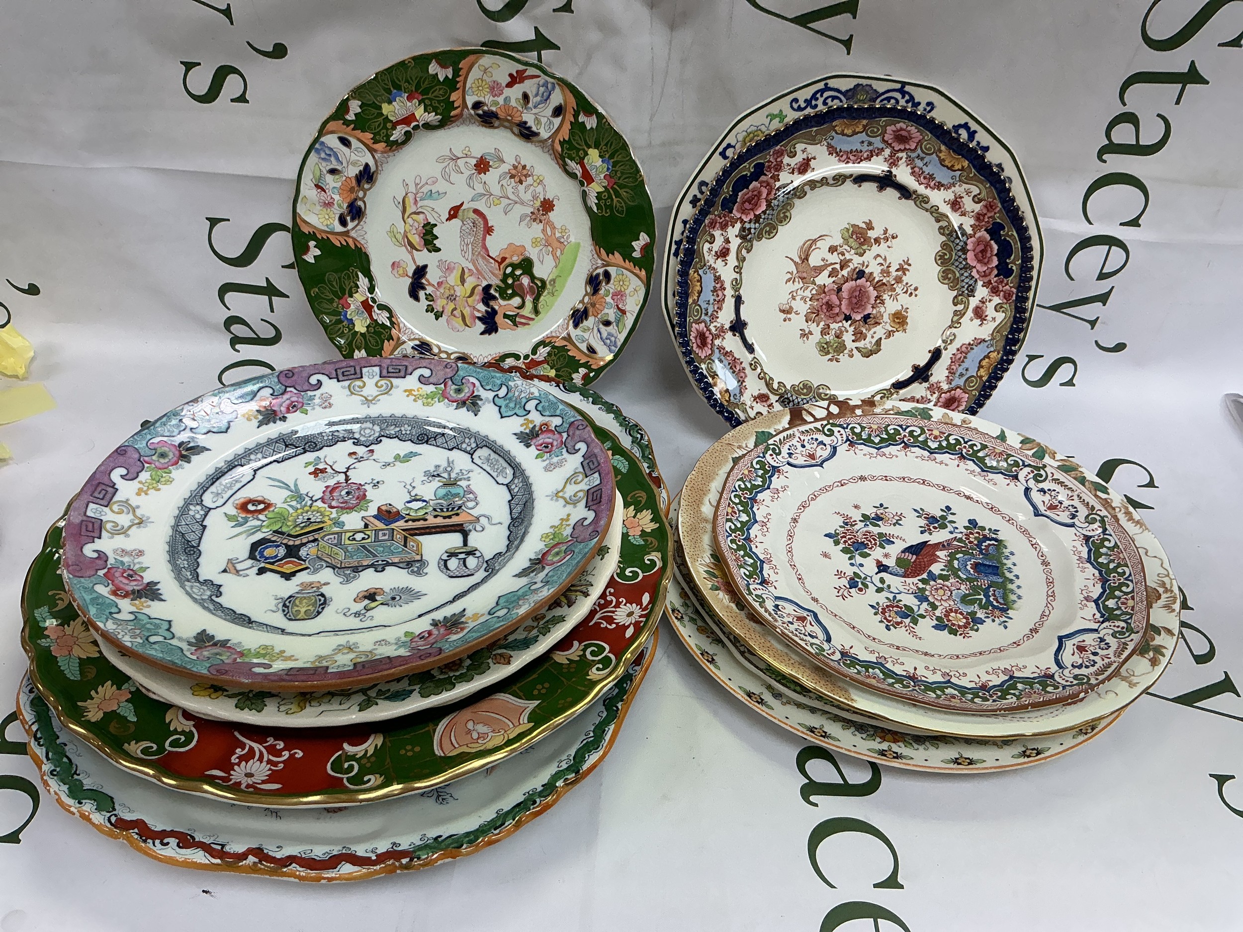 A box of plates decorated in the Oriental style, various makes including Royal Crown Derby, Masons and others.
