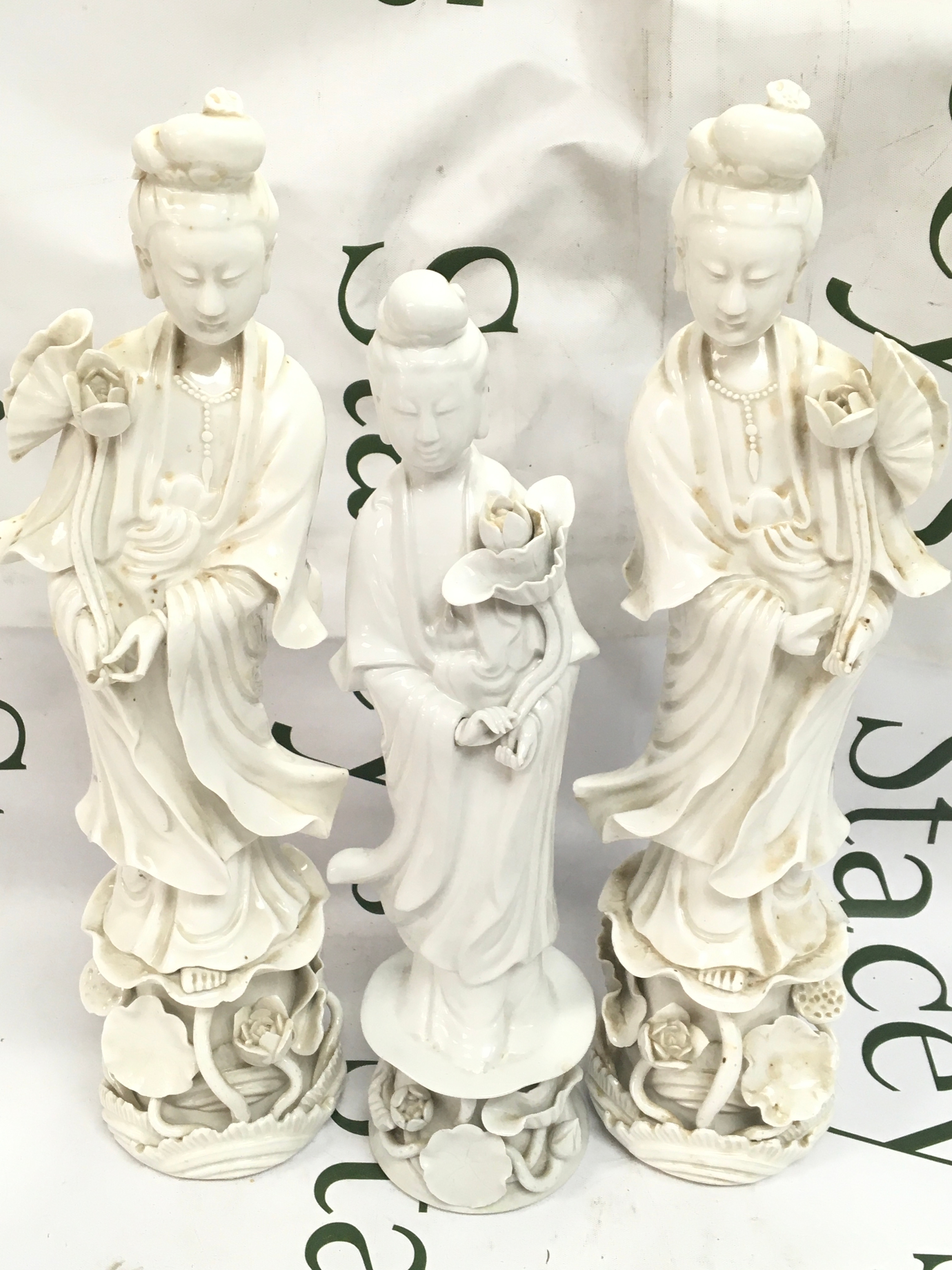 Vintage white porcelain figures of Chinese ladies and smaller holding flowers. 31 to 36cm tall. Some damage