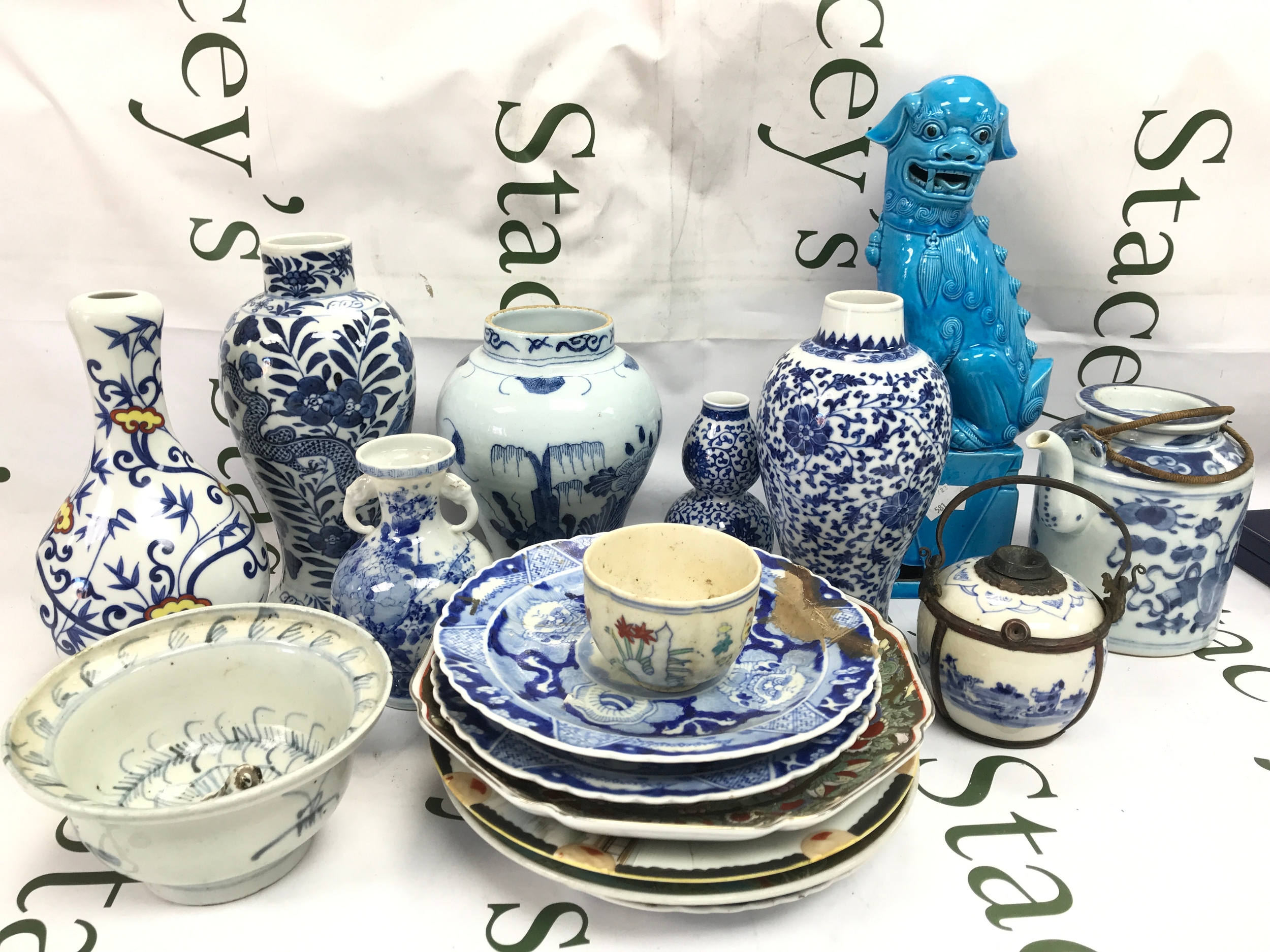 A Collection of Chinese blue and white items including plates, vases, fu dog figure