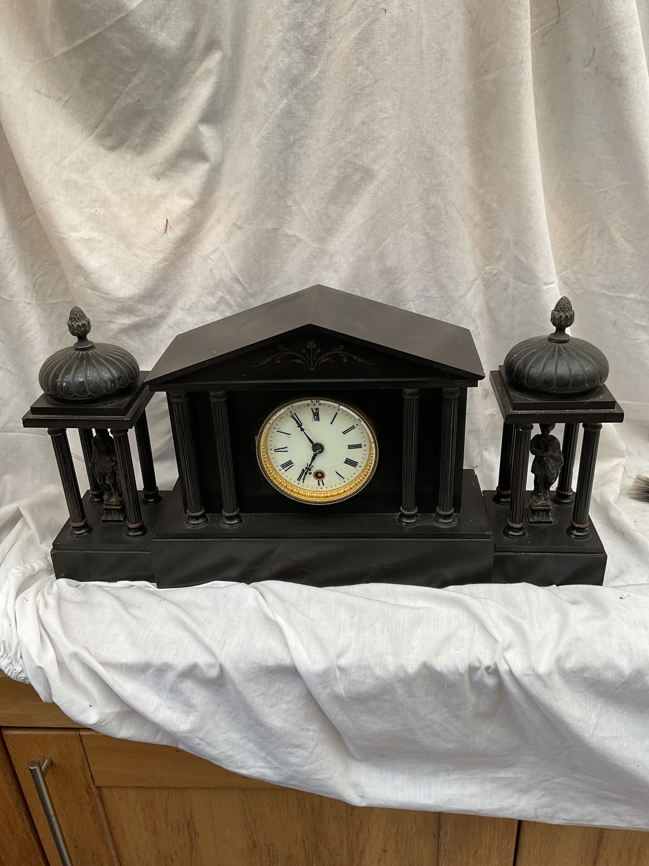 Slate mantle clock garniture with Roman statues.