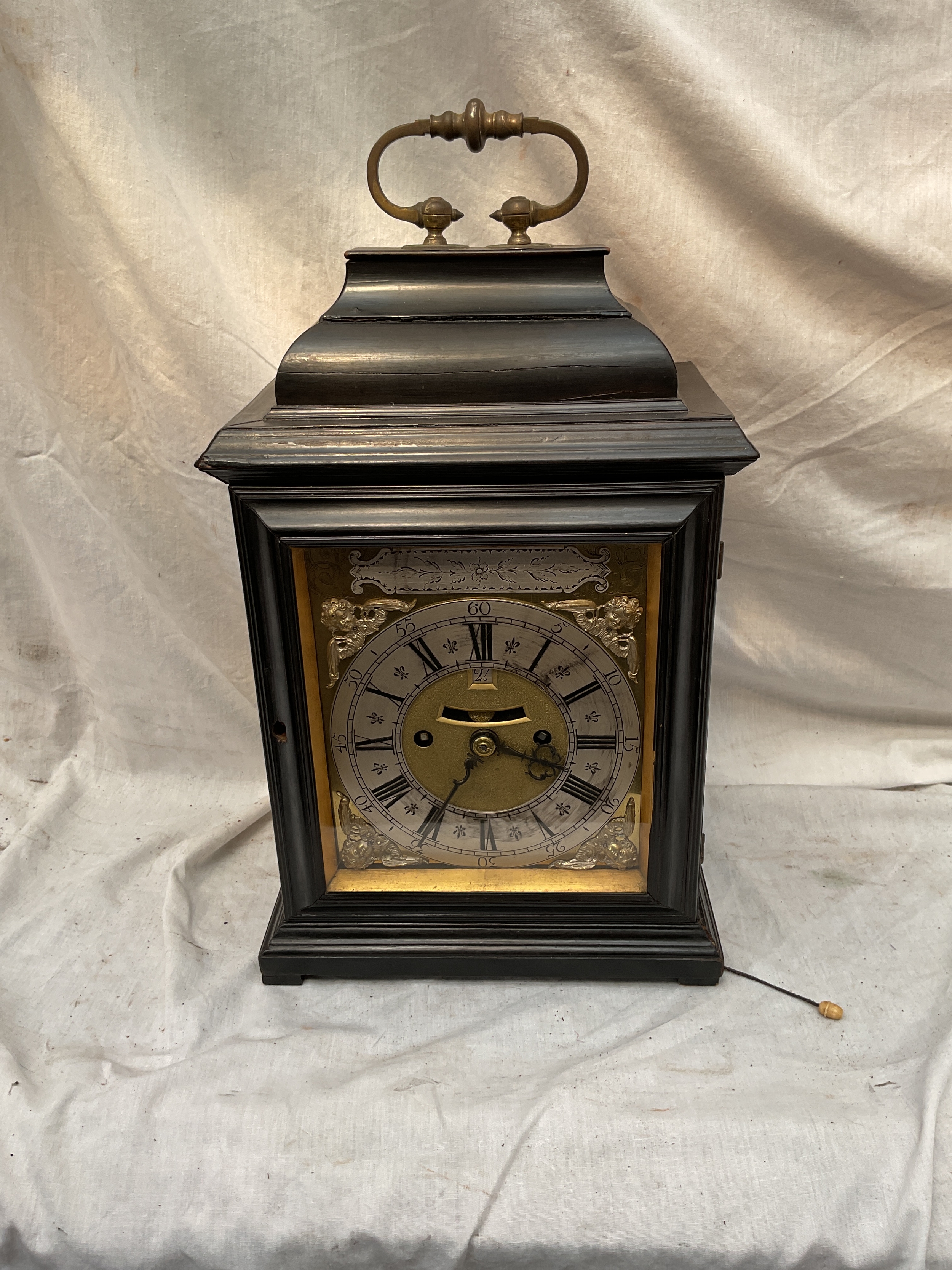 Mid 18th C Bracket hour repeat table clock, with Ormolu carry handle, gilded dial with silver chapter ring, four cherub spandrels, beat minute indicator, and date aperture, twin fusee movement with ornate scrollwork to the back with fruit crown face engraved pertaining to the Lord Mayor in 1735, H 43 cm x W 24.5 cm x D 16 cm.