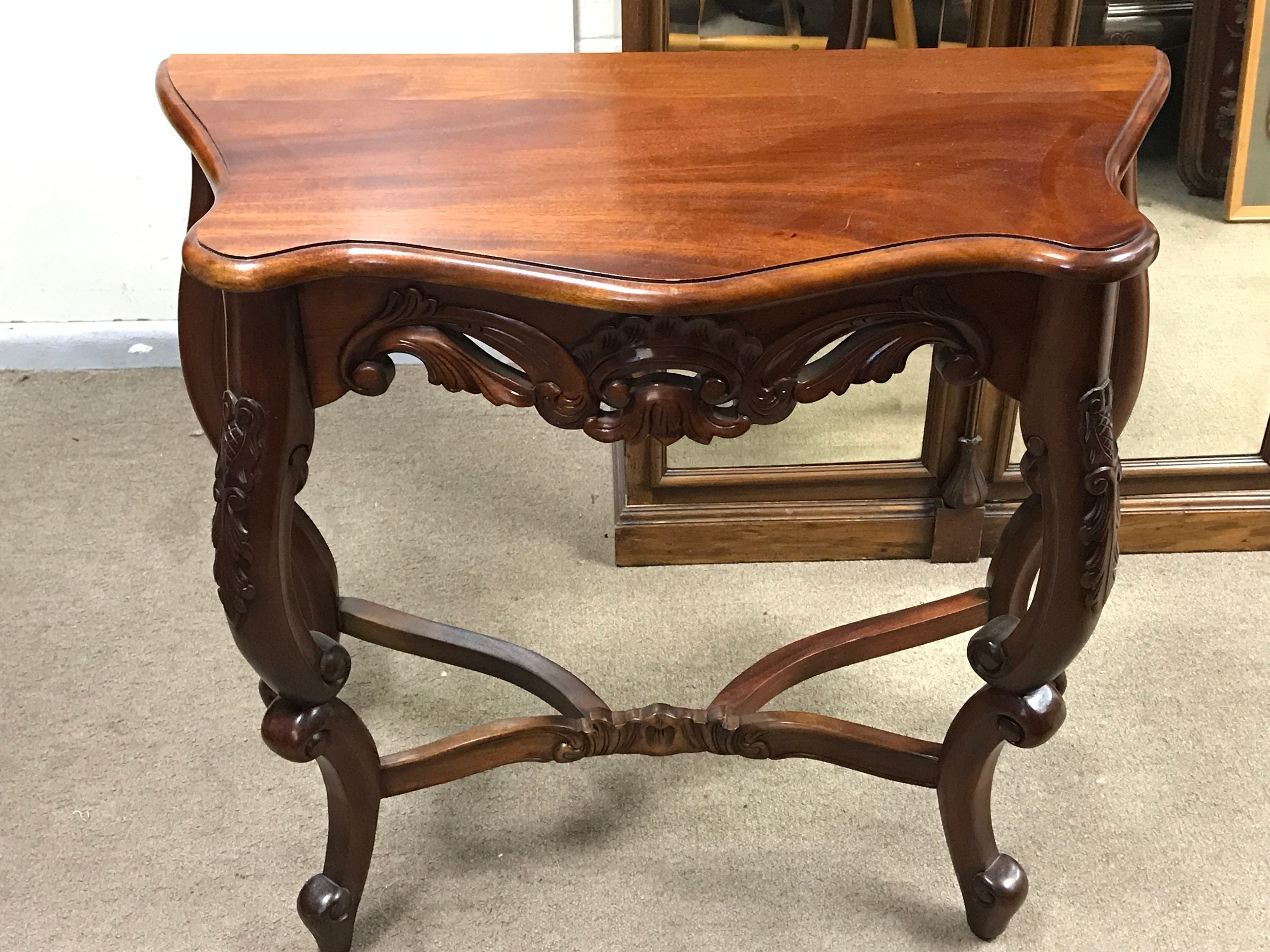 A Mahogany Victorian side table, serpentine top, cabriole legs and a cross stretcher base. 80cm wide, 75cm tall, 36cm long TO BE SOLD WITHOUT RESERVE