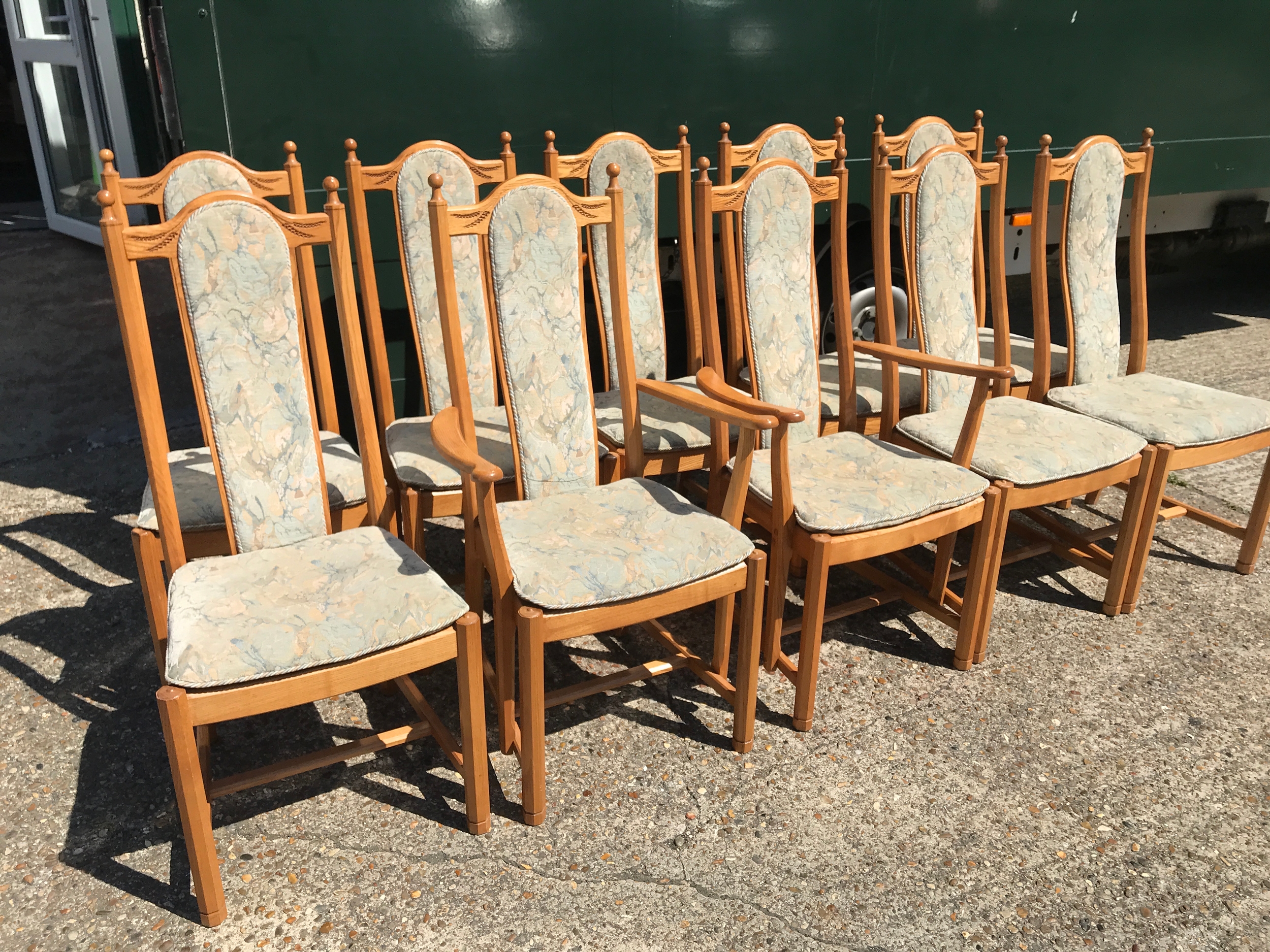 A set of Ercol dining chairs with upholstered backs and seats, two with arm rests. 10 in total. Chair dimensions 45x48x107cm