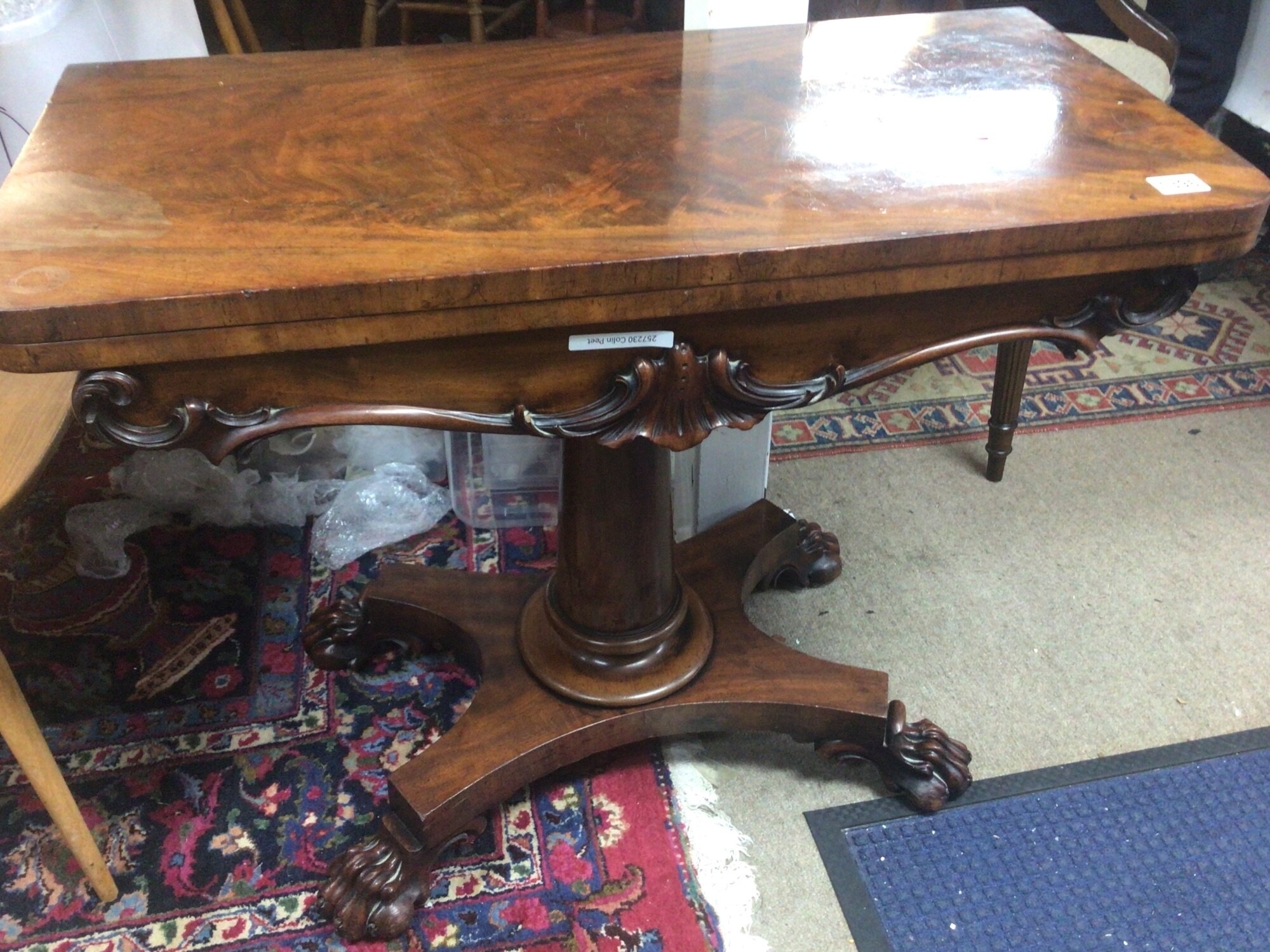 A Victorian Mahogany Card table the twin flap top above a shaped frieze with applied mouldings on a circular column TO BE SOLD WITHOUT RESERVE