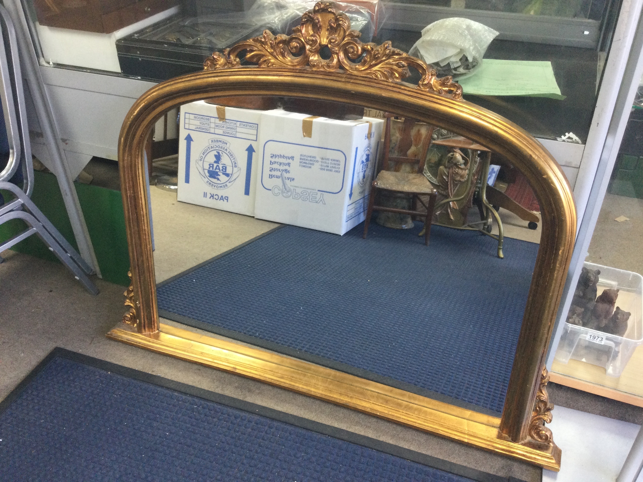 A large gilt arched overmantel mirror. 120cm wide 90cm tall