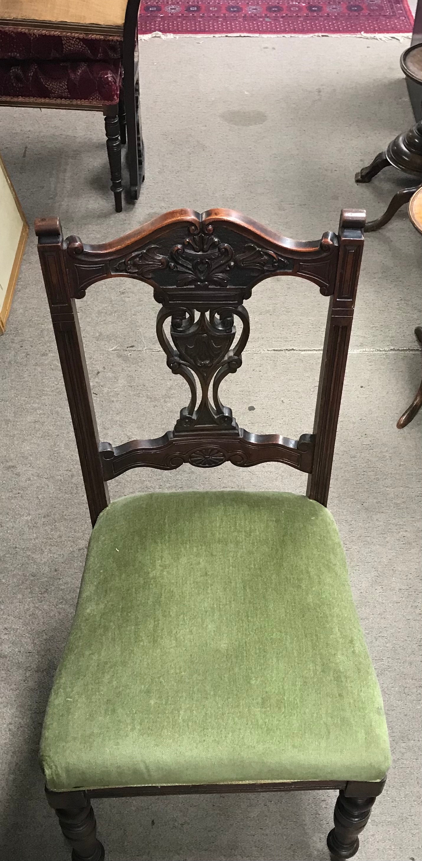 A set of six dining chairs with green upholstery
