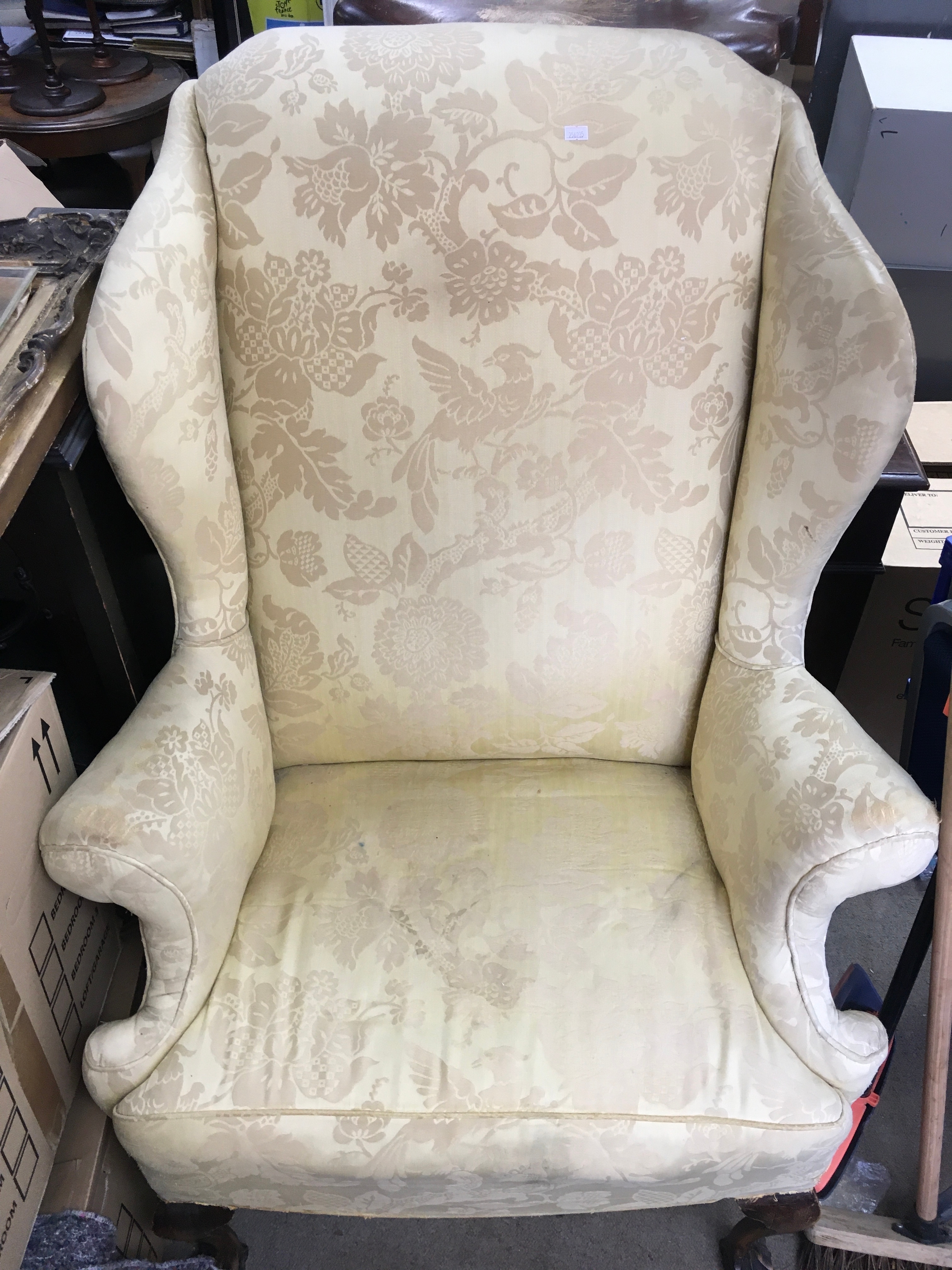 A wing back open armchair TO BE SOLD WITHOUT RESERVE