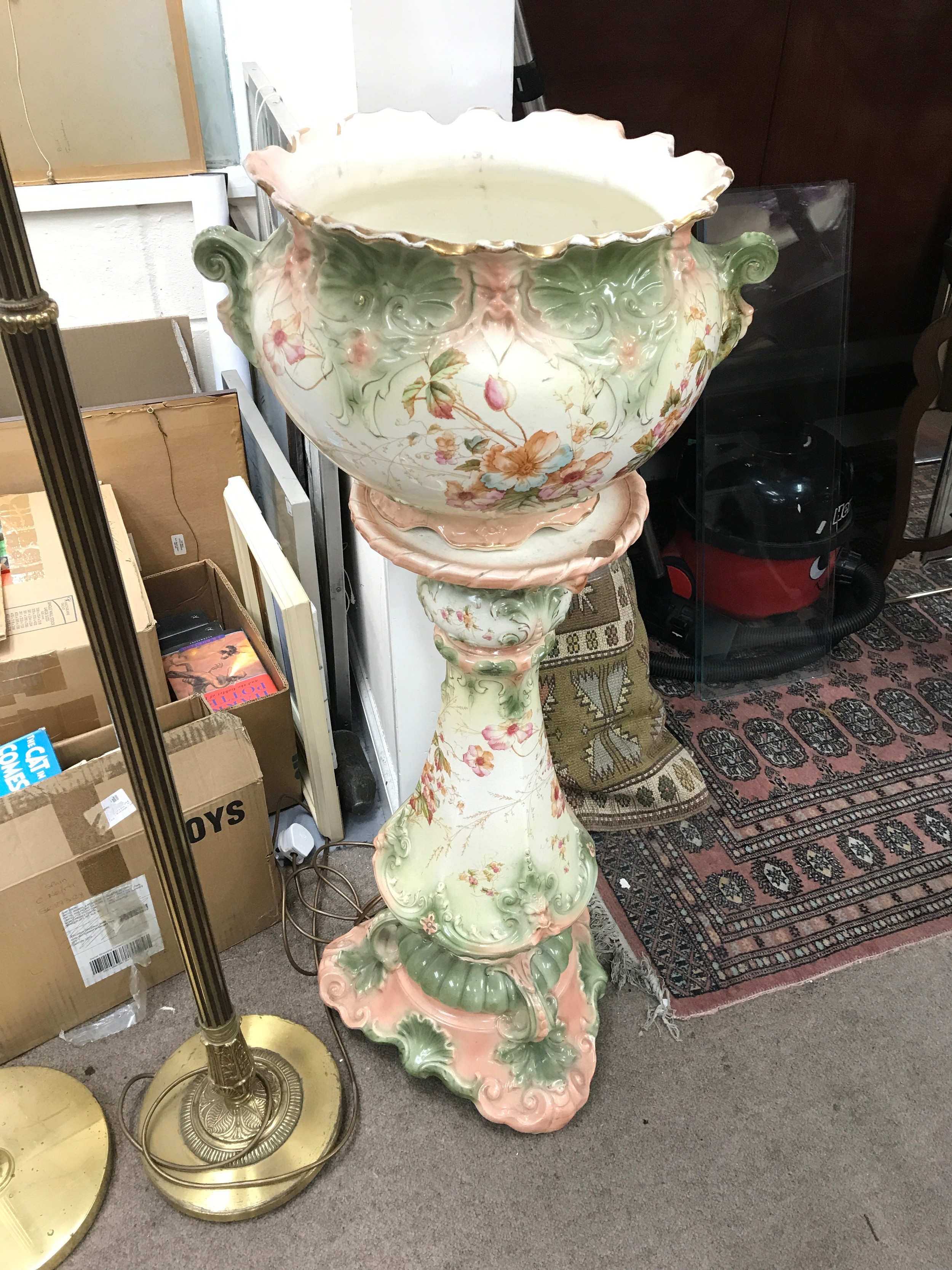 A ceramic jardiniere on a matching pedestal stand, highlighted by a scalloped, pink-tinted rim with delicate gilded trim 104cm tall