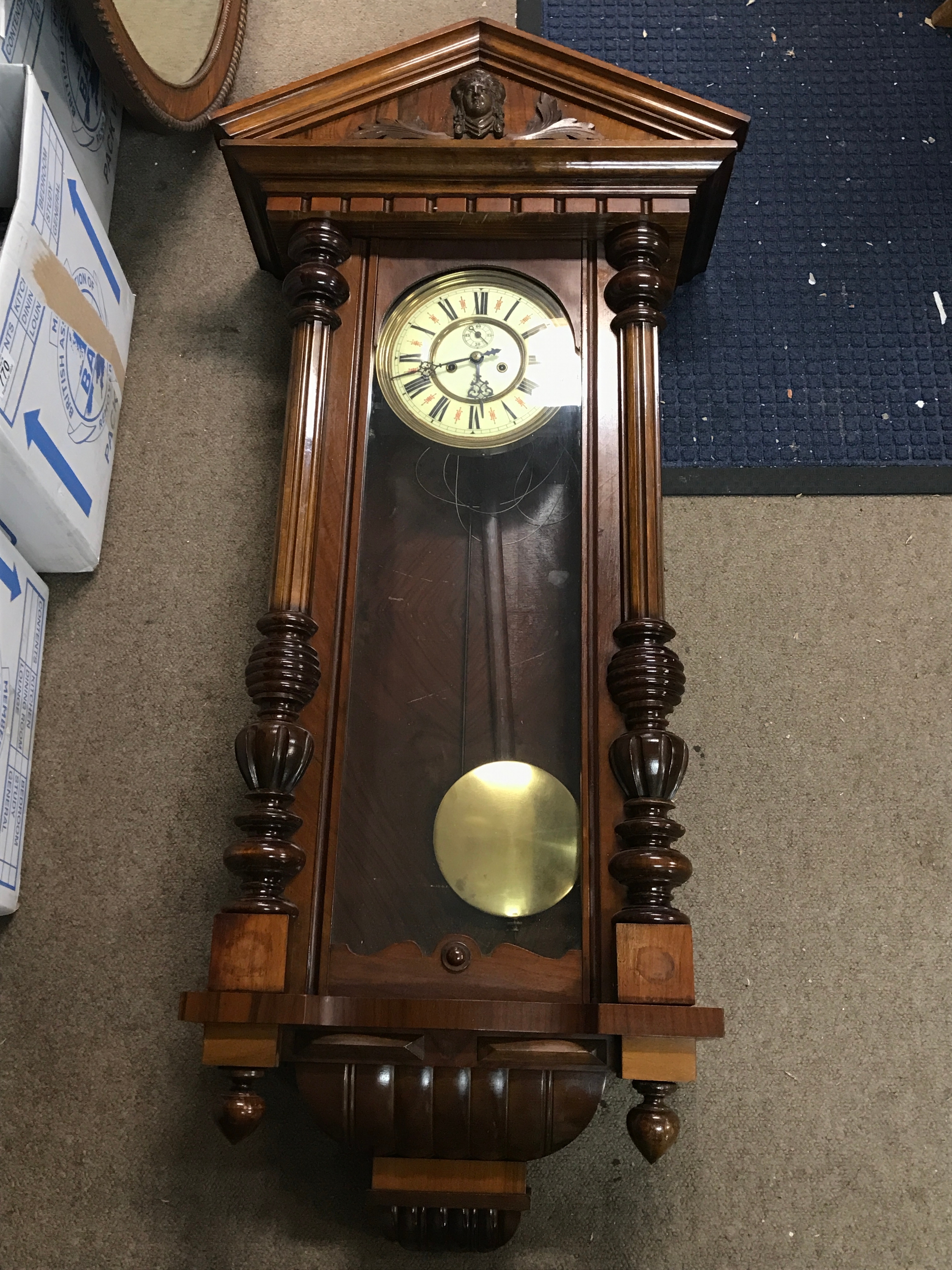 A wall clock, 118cm tall, 55cm wide