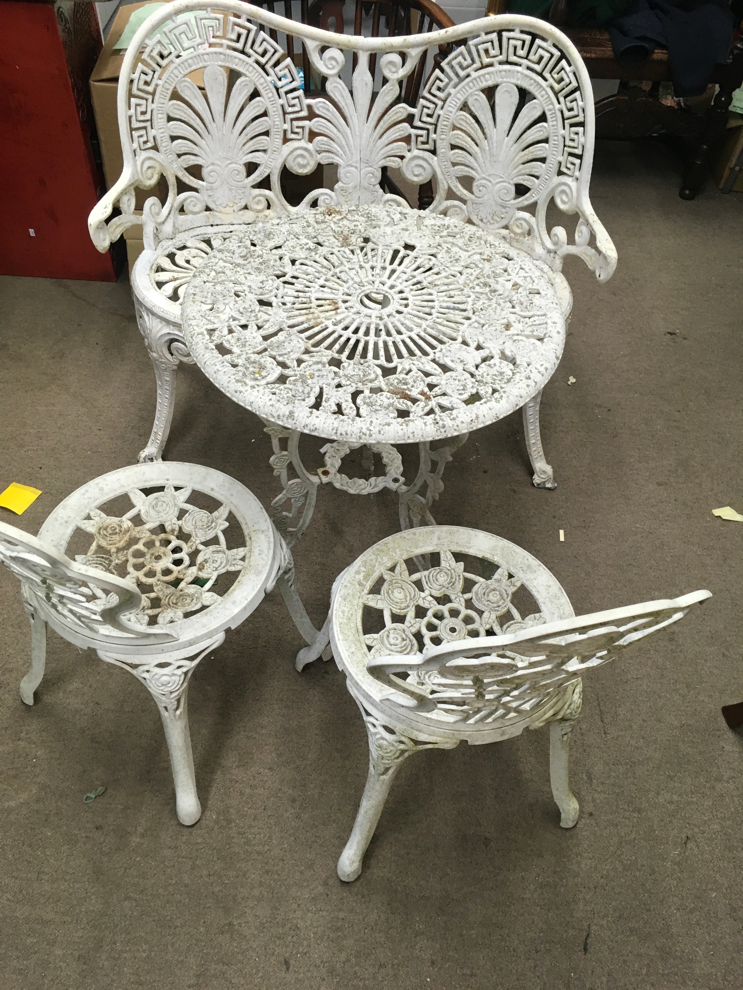 Vintage style white cast iron garden table and chairs with a bench