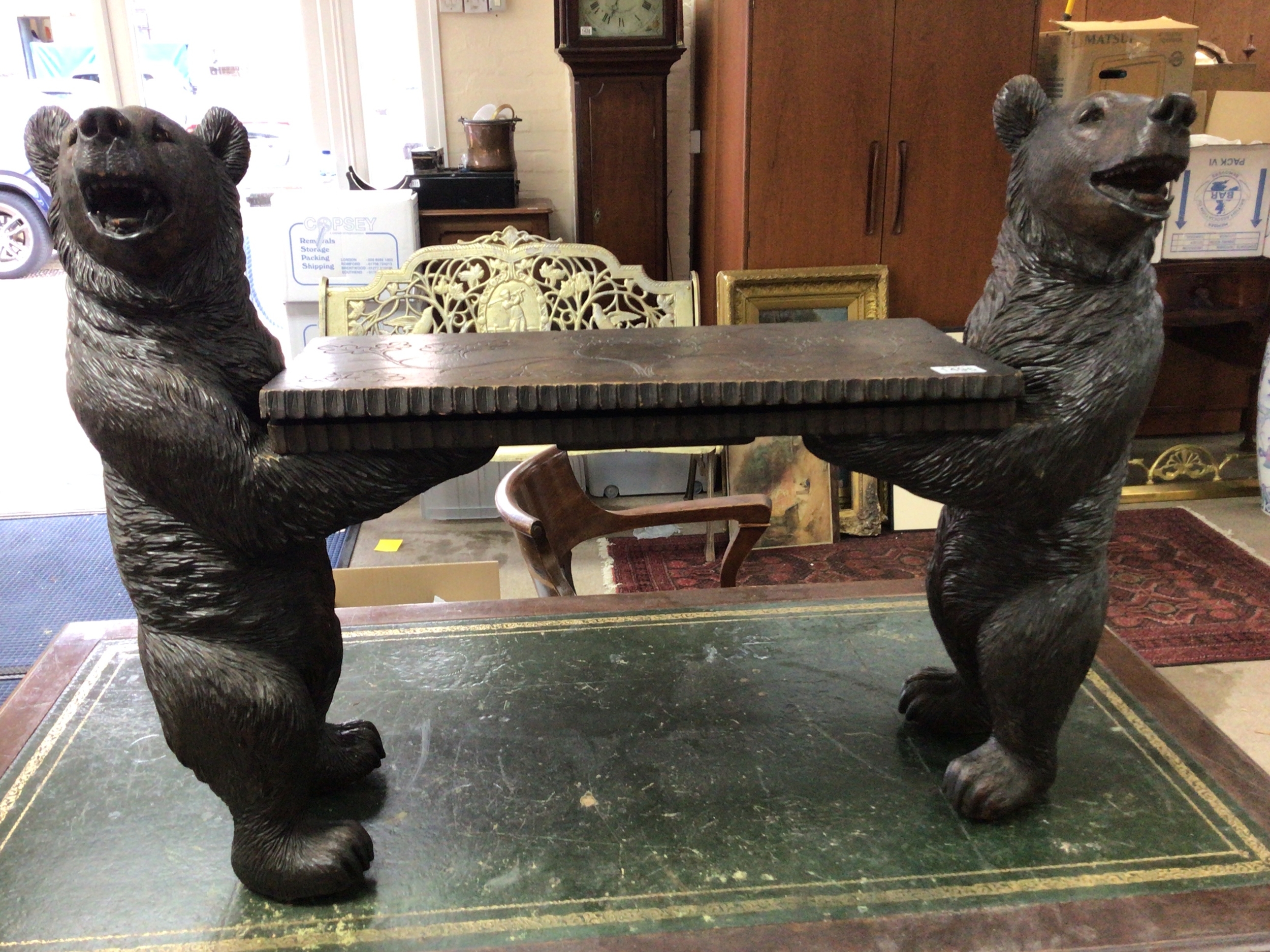 A quality late 19th century Black Forest Bear Musical seat the seat with a small mechanical music box flaked by two bears with open mouths and glass eyes Height 68cm length 96cm