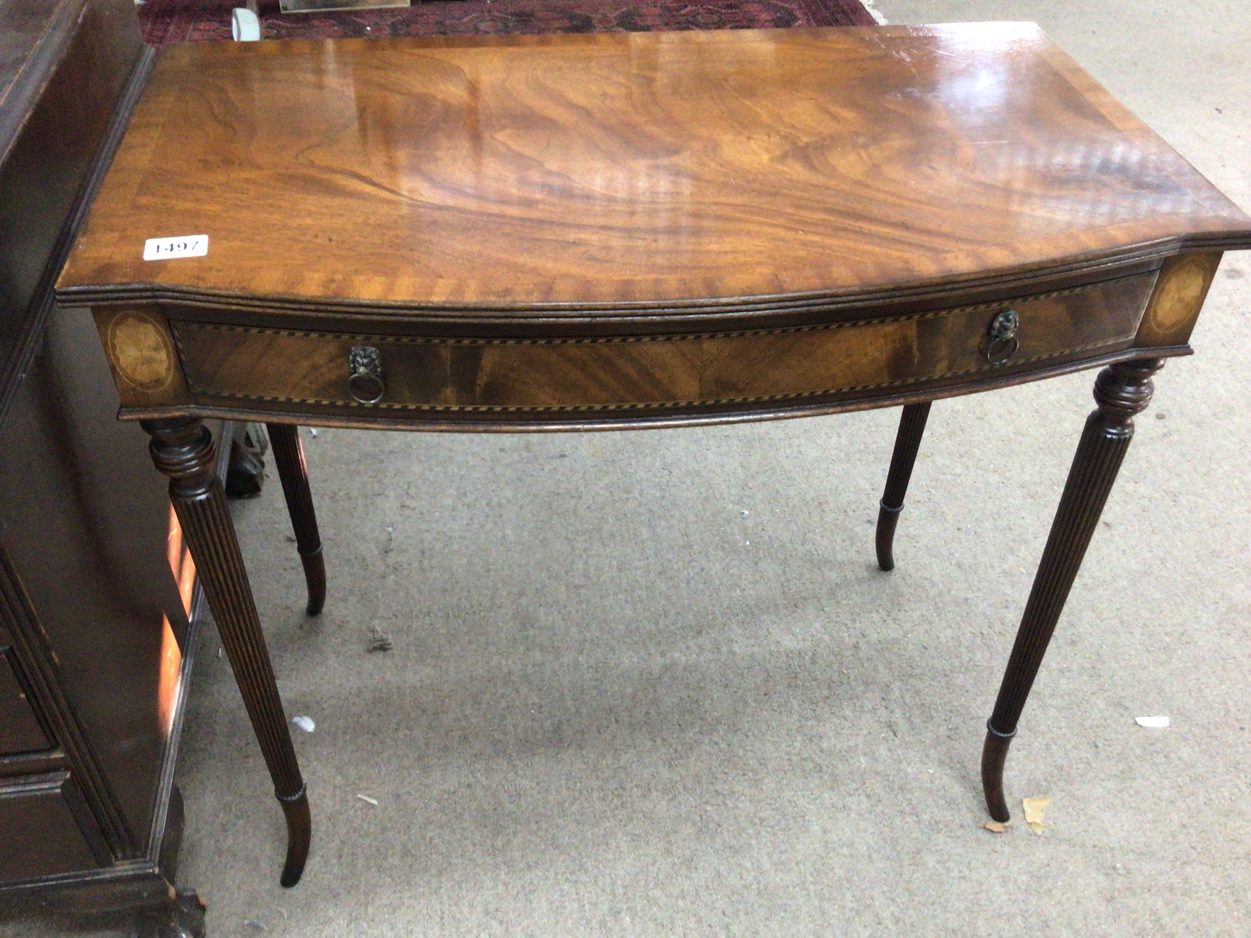 A mahogany side table the cross banded edge above a single drawer on turned and fluted legs. 80cm