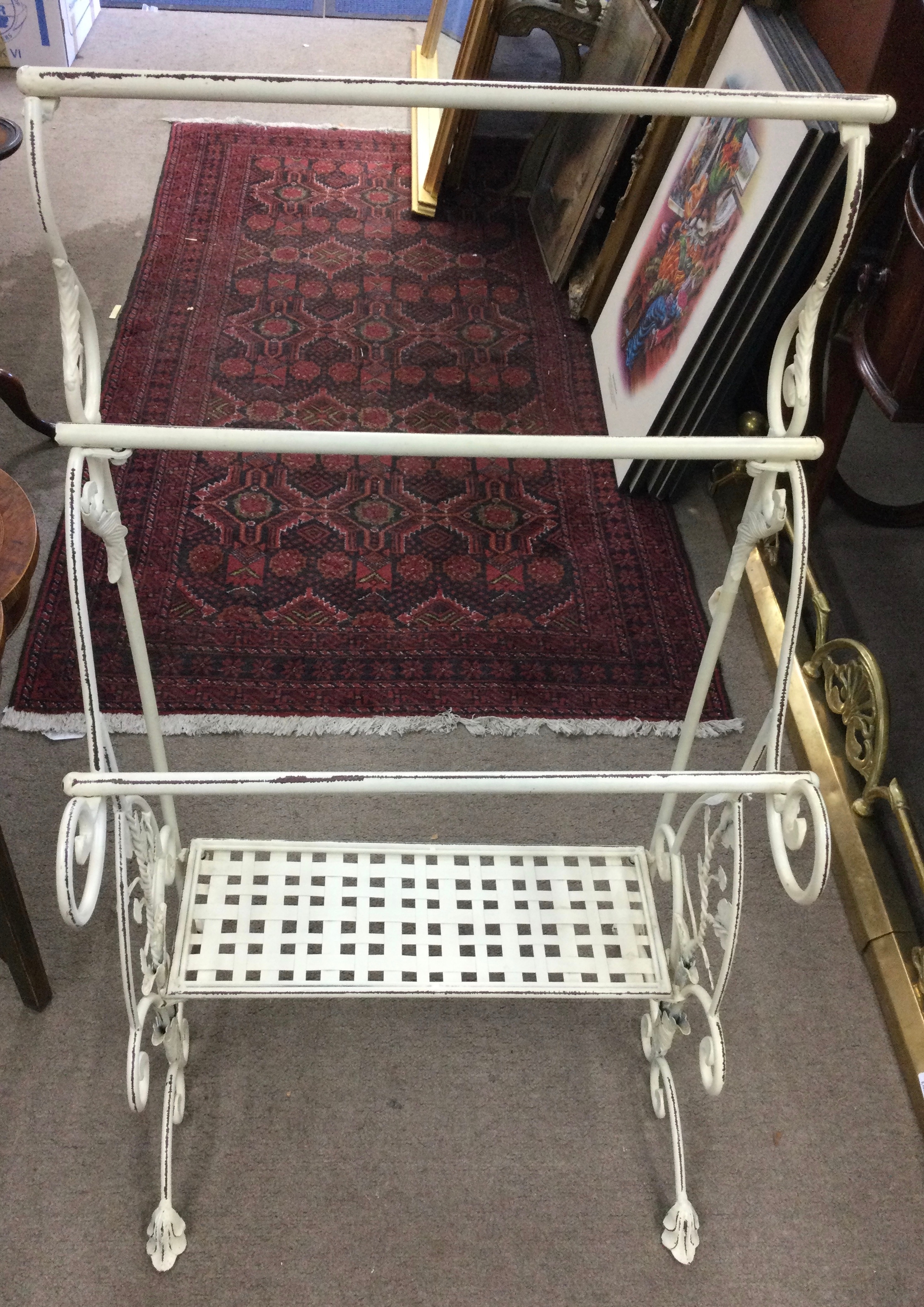 A modern, cream painted metal rail with under shelf. Approx 56 x 100cm