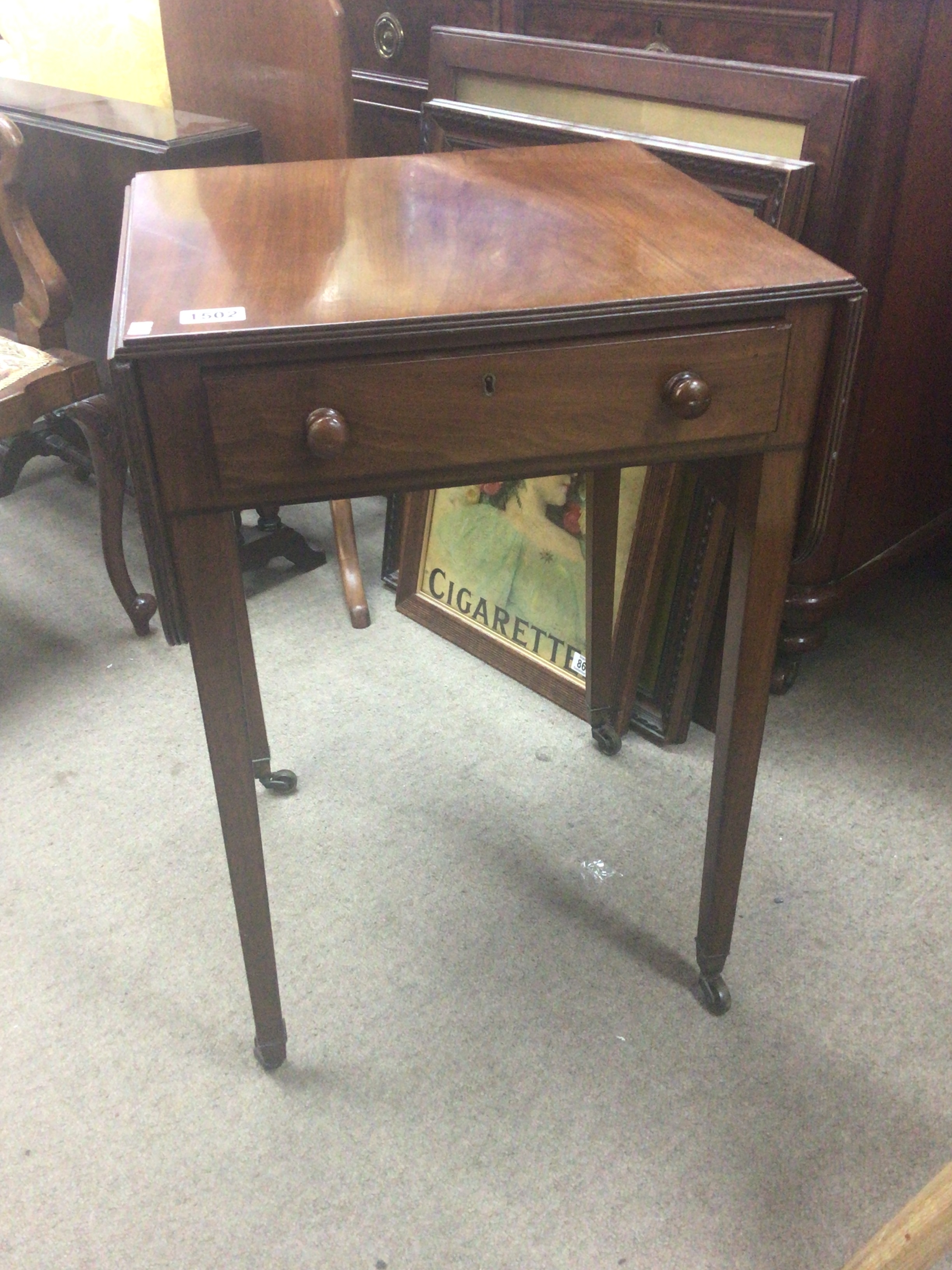 A late 19th century mahogany side table with a single drawer twin flap top above a single drawer on square legs. 