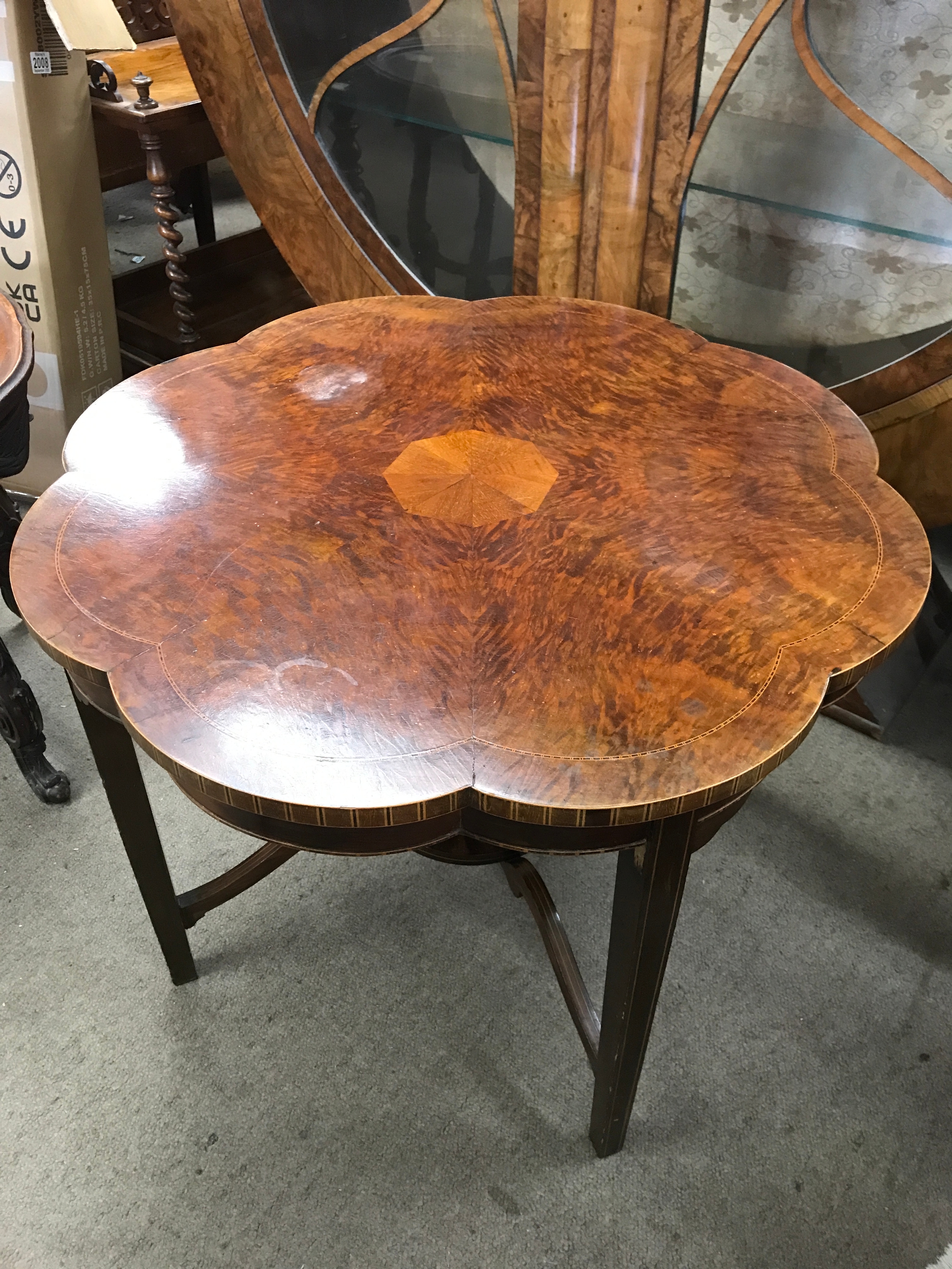A burr walnut scalloped-edge coffee table with inlaid design. 68cm wide 52cm tall