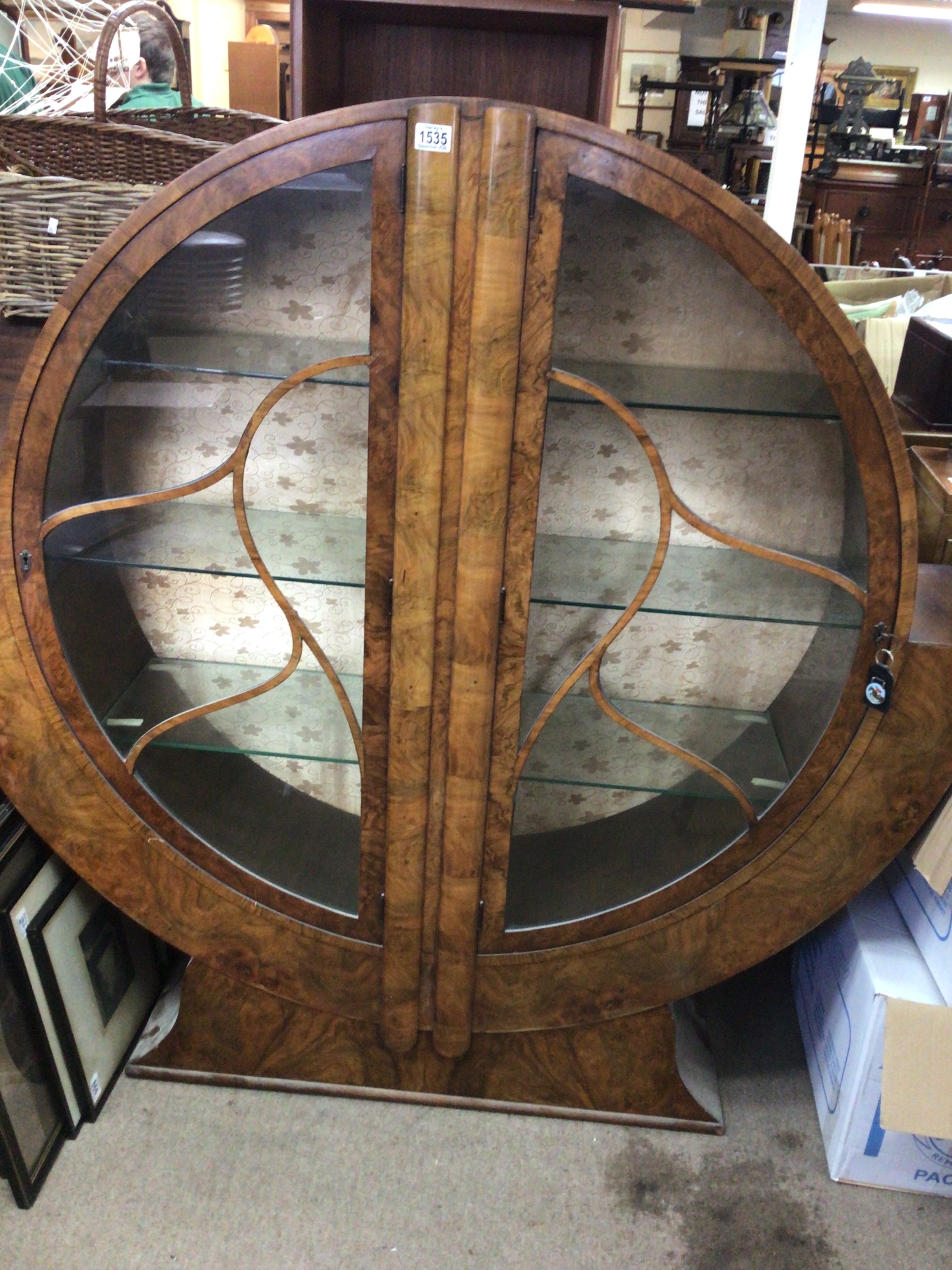  A Nice Example of An Art Deco walnut display cabinet with geometric glazed doors central hinged of circular shape flanked with wide shaped wings