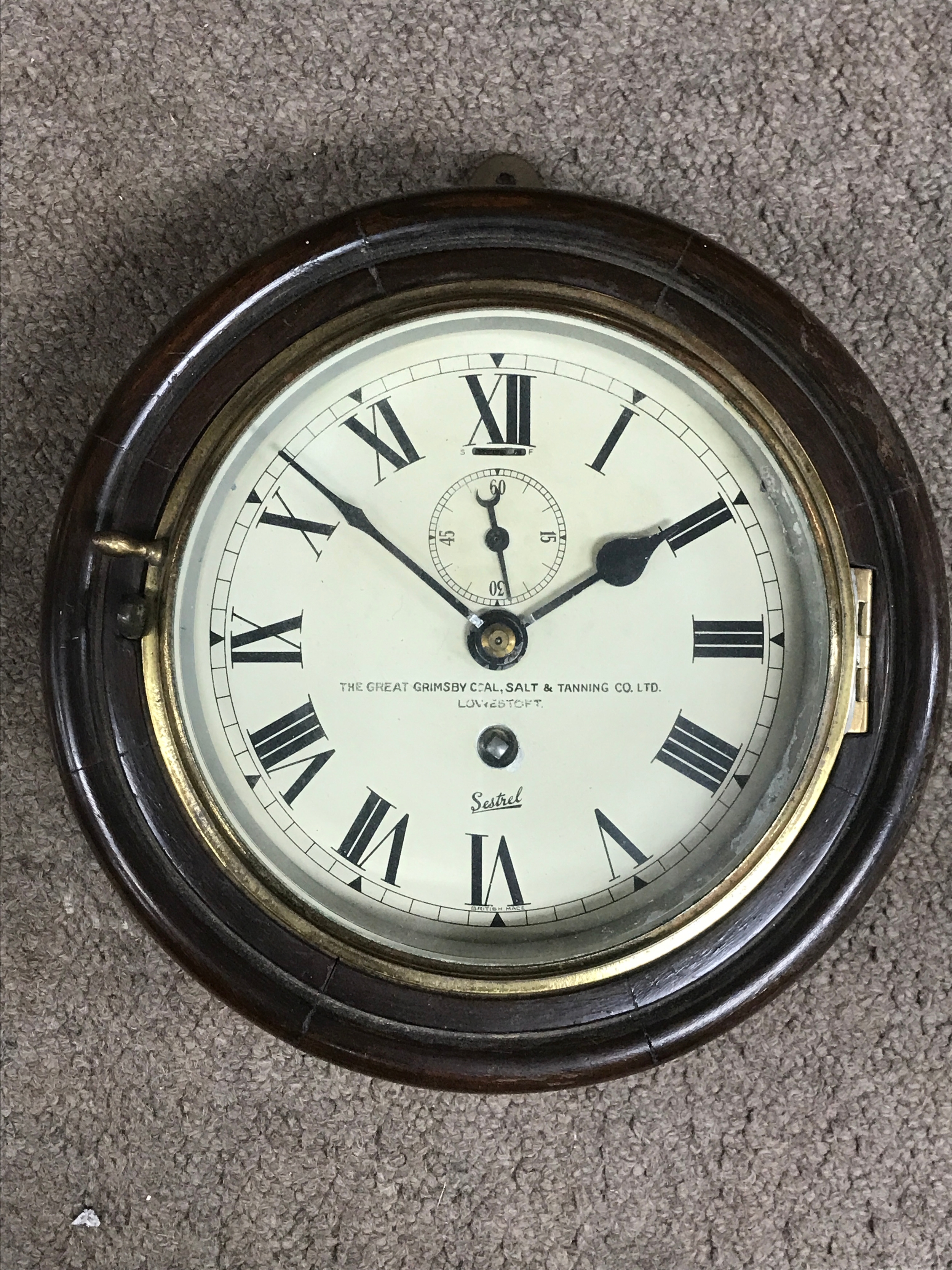 A wall clock The Geat Grimsby Coal, Salt and Tanning Co LTD, LOWESTOFT. Sestrel . 22cm wide 