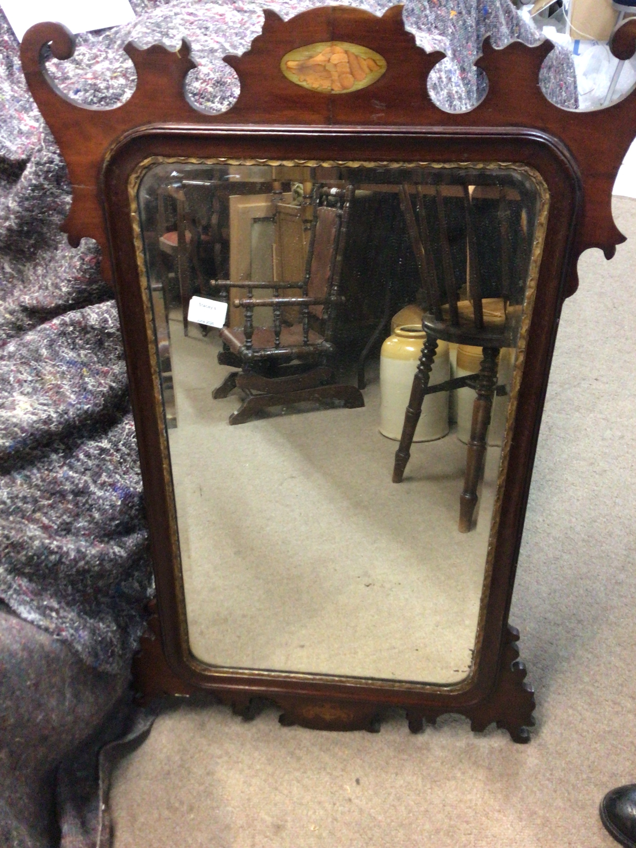  A George IlI mahogany wall mirror the shaped top inlaid with a shell motif. with a beloved edge mirror. 98x59cm