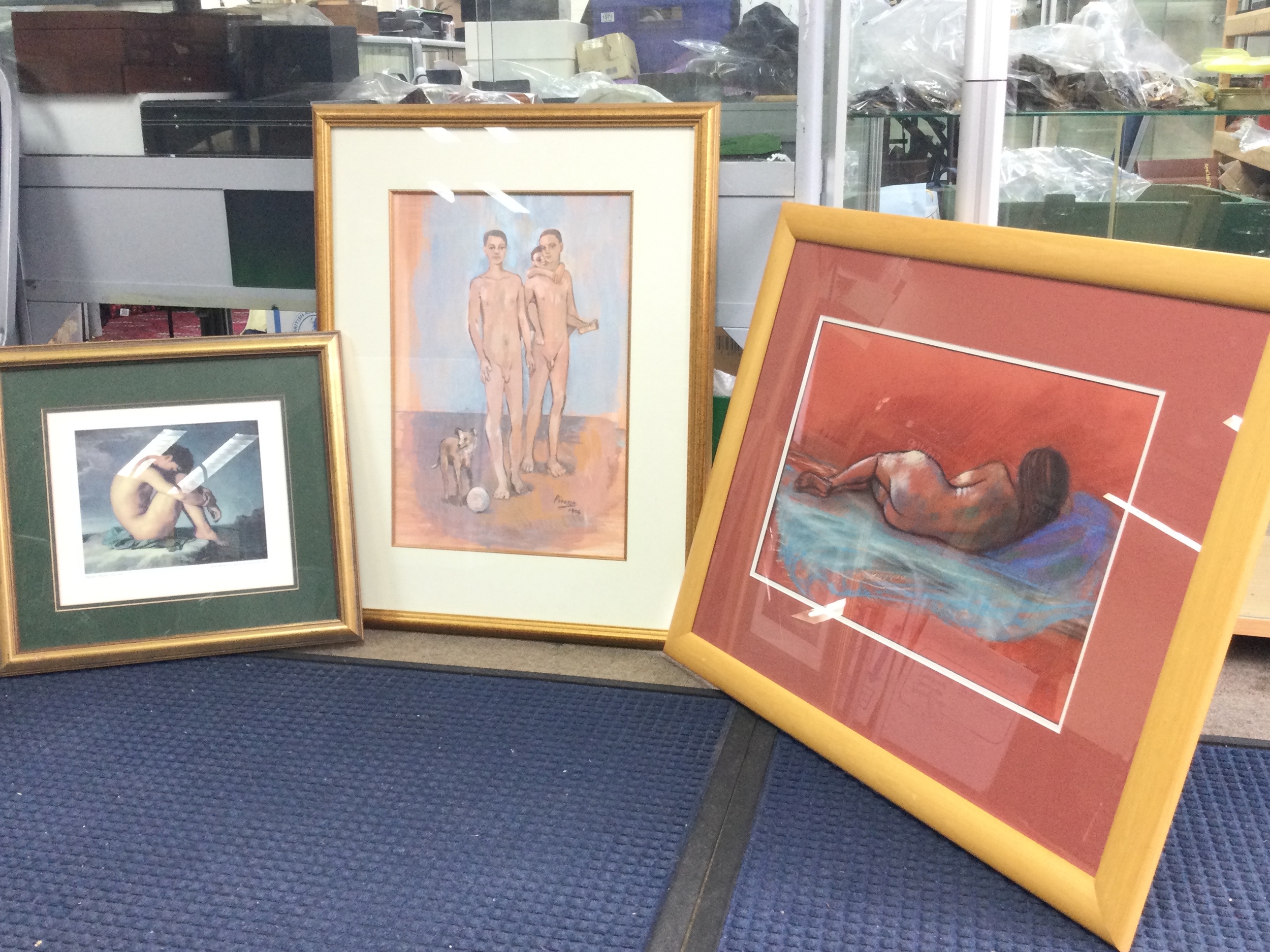 Three framed nude pictures- a print of Pablo Picasso's On the Beach, reclining nude figure, nude woman laying
