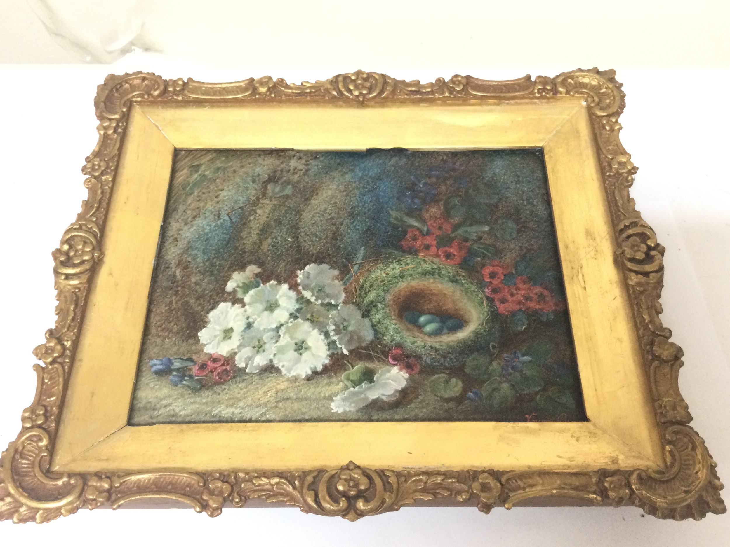 A framed oil on canvas painting by Vincent Clare of a nest of bird eggs, 23x19cm frame 34x29cm.