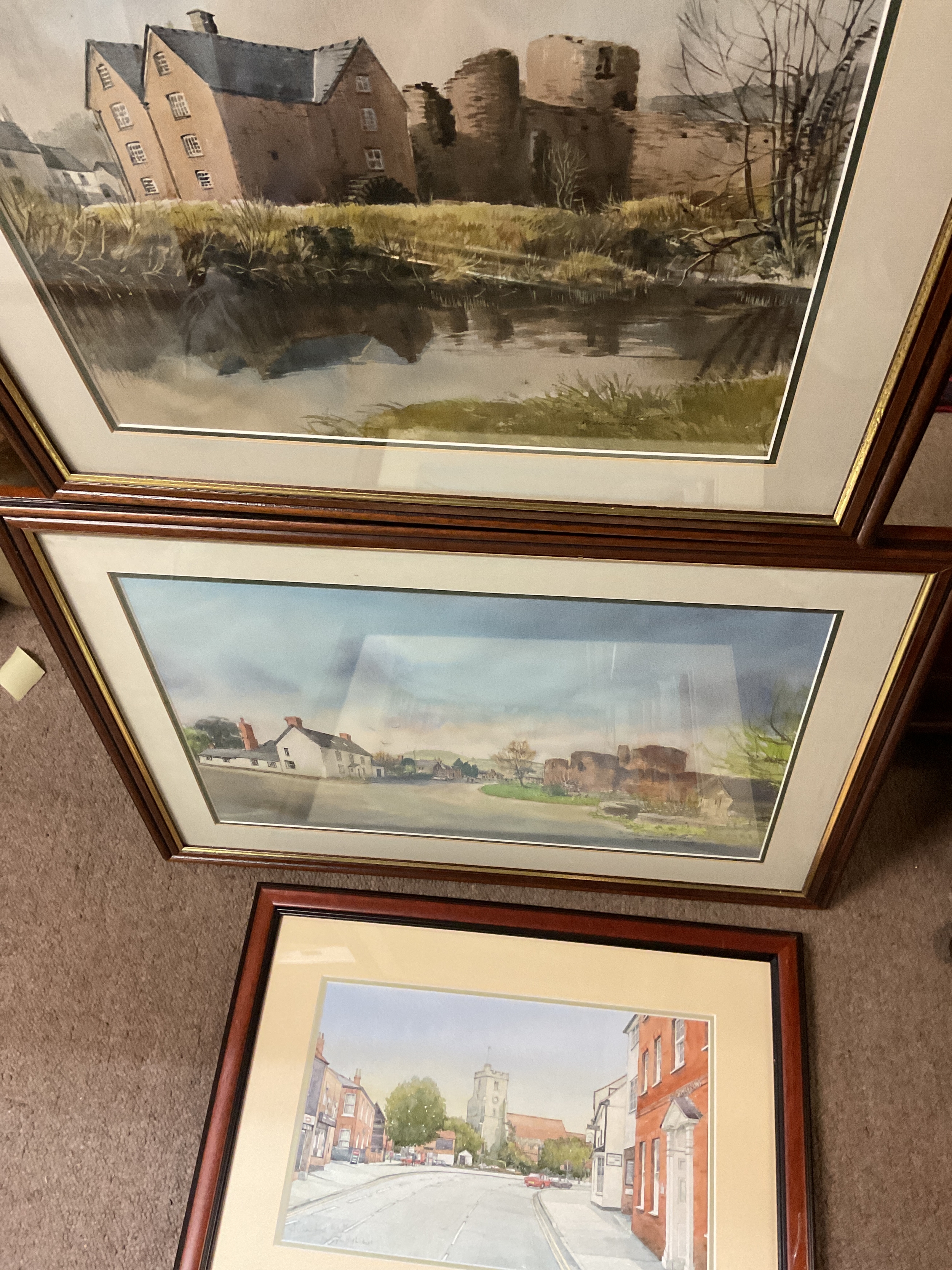 Three framed and glazed watercolours of town scenes.